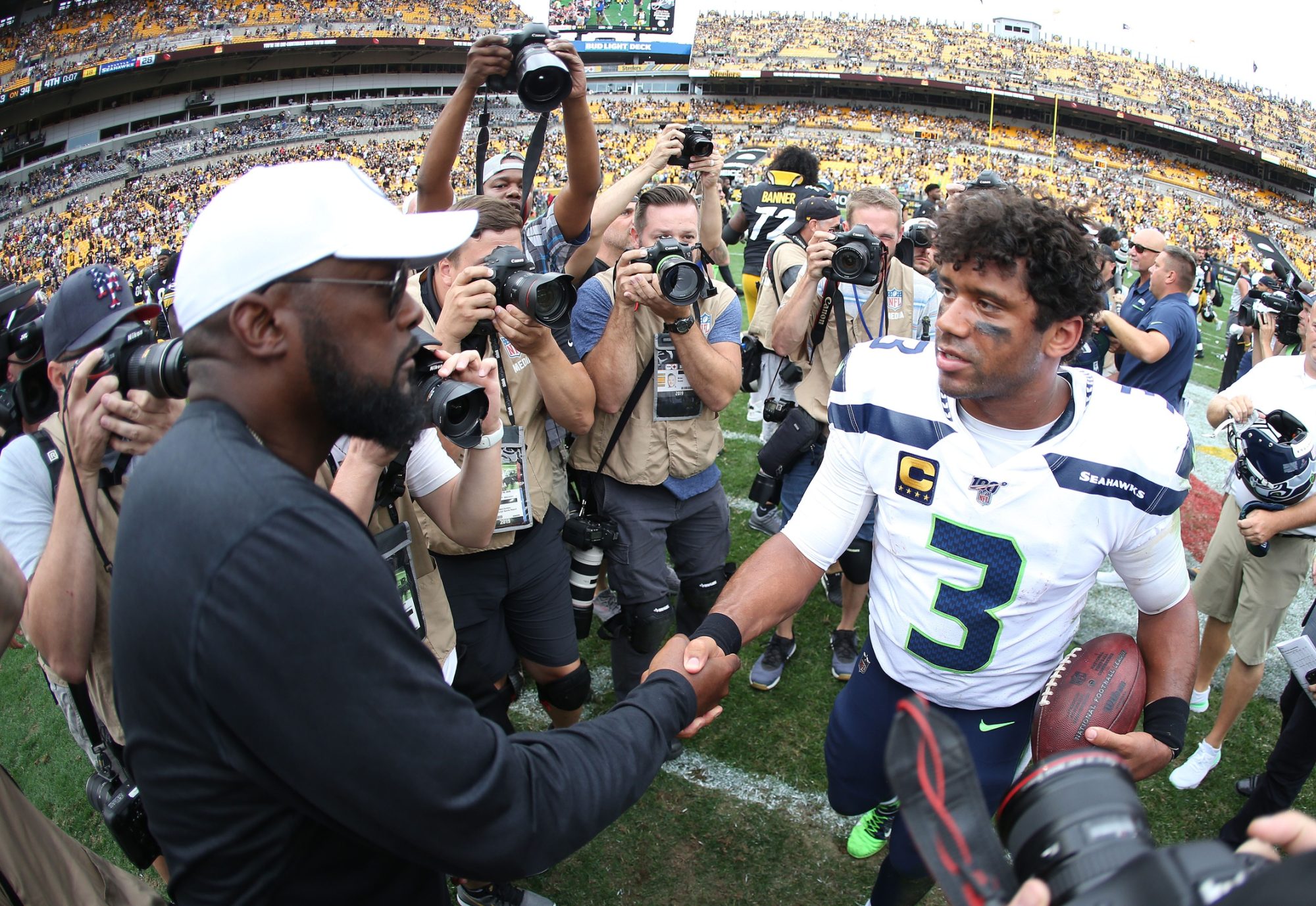 Sep 15, 2019; Pittsburgh, PA, USA; Pittsburgh Steelers head coach Mike Tomlin (left) and Seattle Seahawks quarterback Russell Wilson (3) shake hands after a game at Heinz Field.