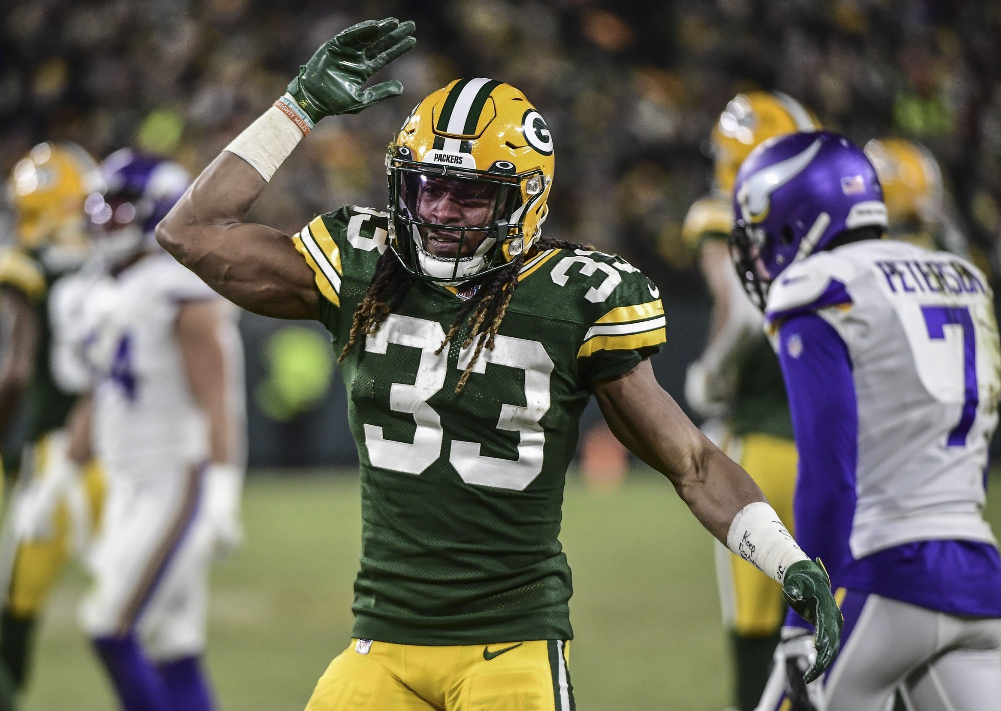 Jan 2, 2022; Green Bay, Wisconsin, USA; Green Bay Packers running back Aaron Jones (33) reacts after running the ball for a first down in the second quarter against the Minnesota Vikings at Lambeau Field.