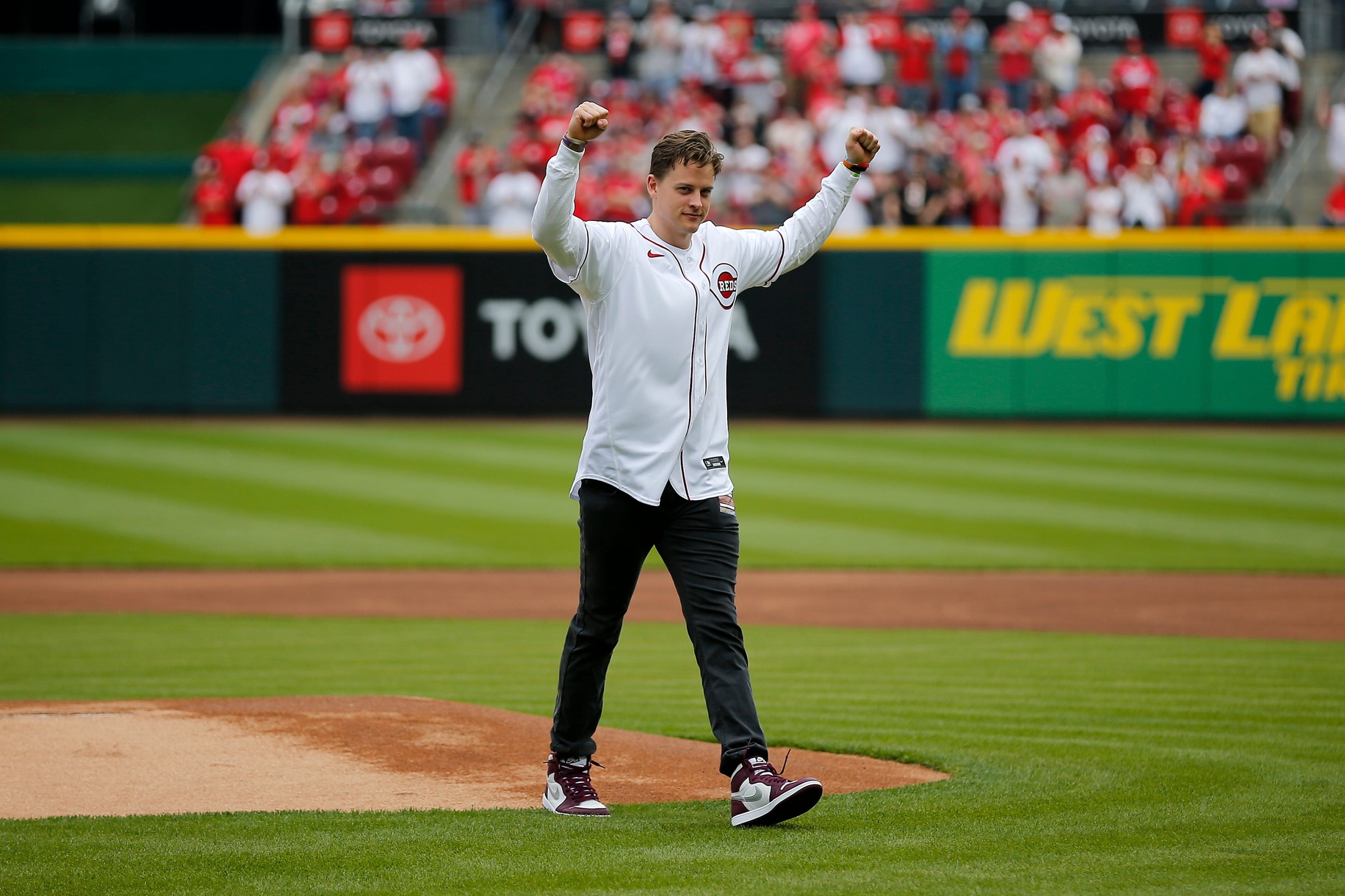 Cincinnati Bengals quarterback Joe Burrow throws a ceremonial first pitch before the Reds home opening game between the Cincinnati Reds and the Cleveland Guardians at Great American Ball Park in downtown Cincinnati on Tuesday, April 12, 2022.