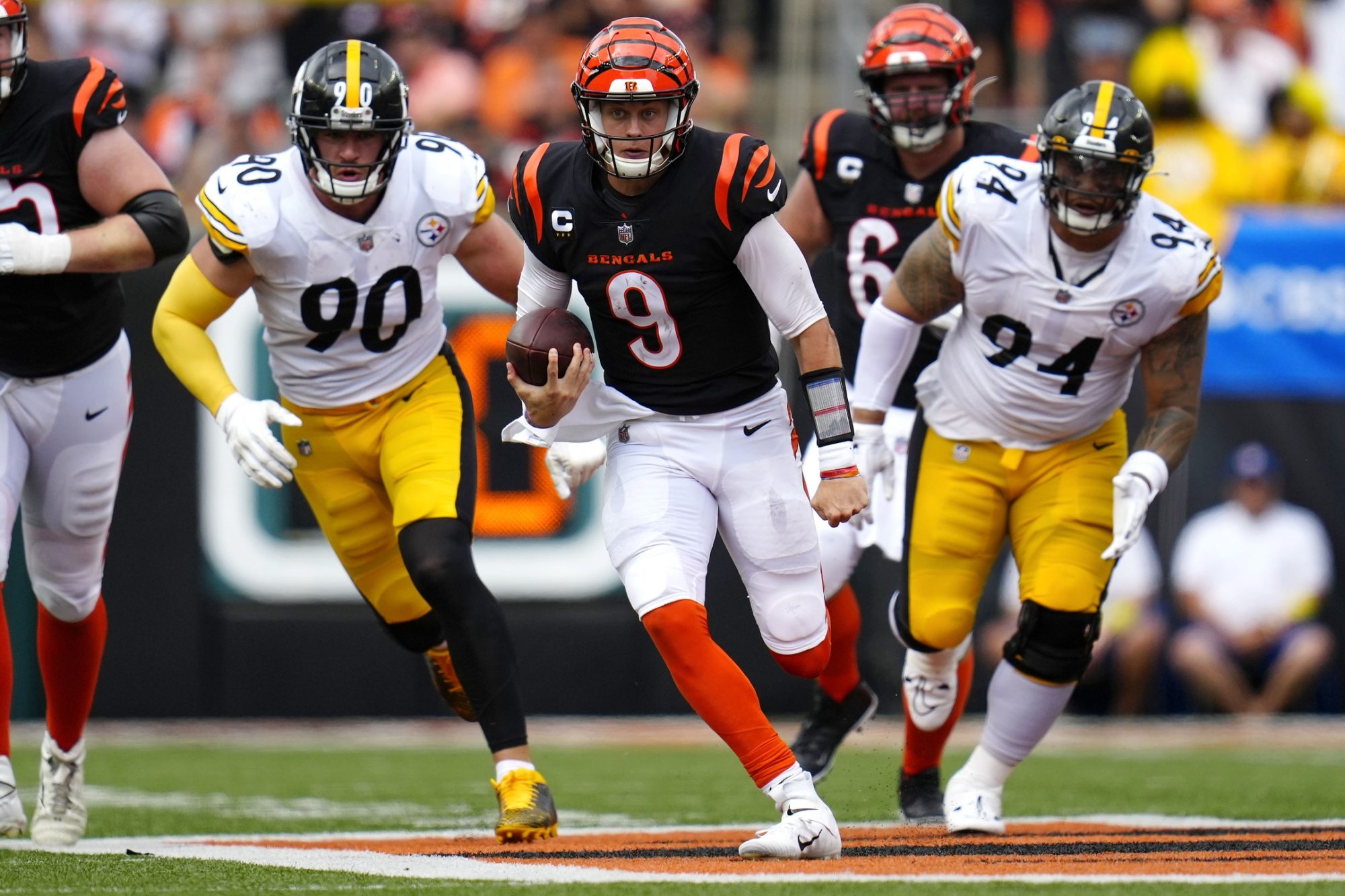 Sep 11, 2022; Cincinnati, Ohio, USA; Cincinnati Bengals quarterback Joe Burrow (9) runs for a first down during the fourth quarter of a Week 1 NFL football game against the Pittsburgh Steelers at Paycor Stadium.