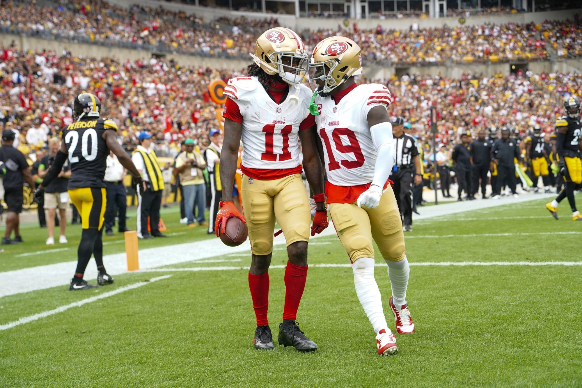 Sep 10, 2023; Pittsburgh, Pennsylvania, USA; San Francisco 49ers wide receiver Deebo Samuel (19) congratulates San Francisco 49ers wide receiver Brandon Aiyuk (11) for catching a touchdown pass against the Pittsburgh Steelers during the first half at Acrisure Stadium.