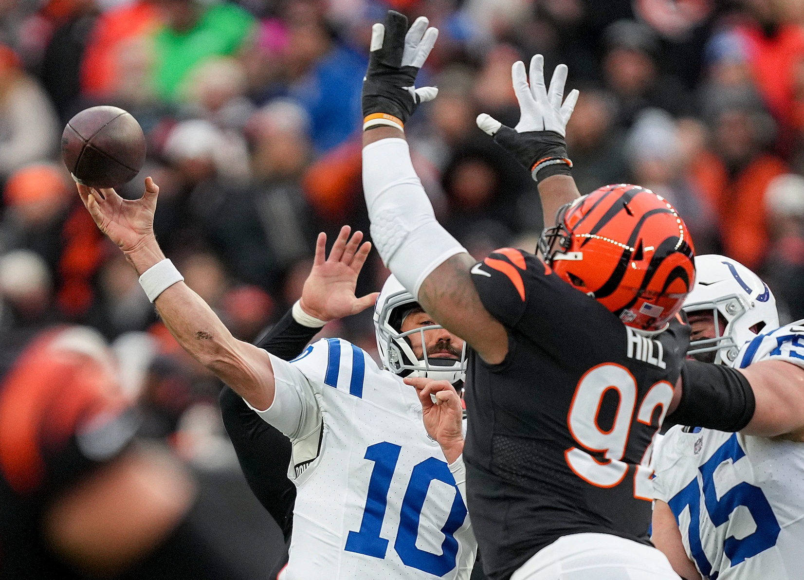 Indianapolis Colts quarterback Gardner Minshew II (10) throws a pass while being covered by Cincinnati Bengals defensive tackle BJ Hill (92) on Sunday, Dec. 10, 2023, during a game against the Cincinnati Bengals at Paycor Stadium in Cincinnati.