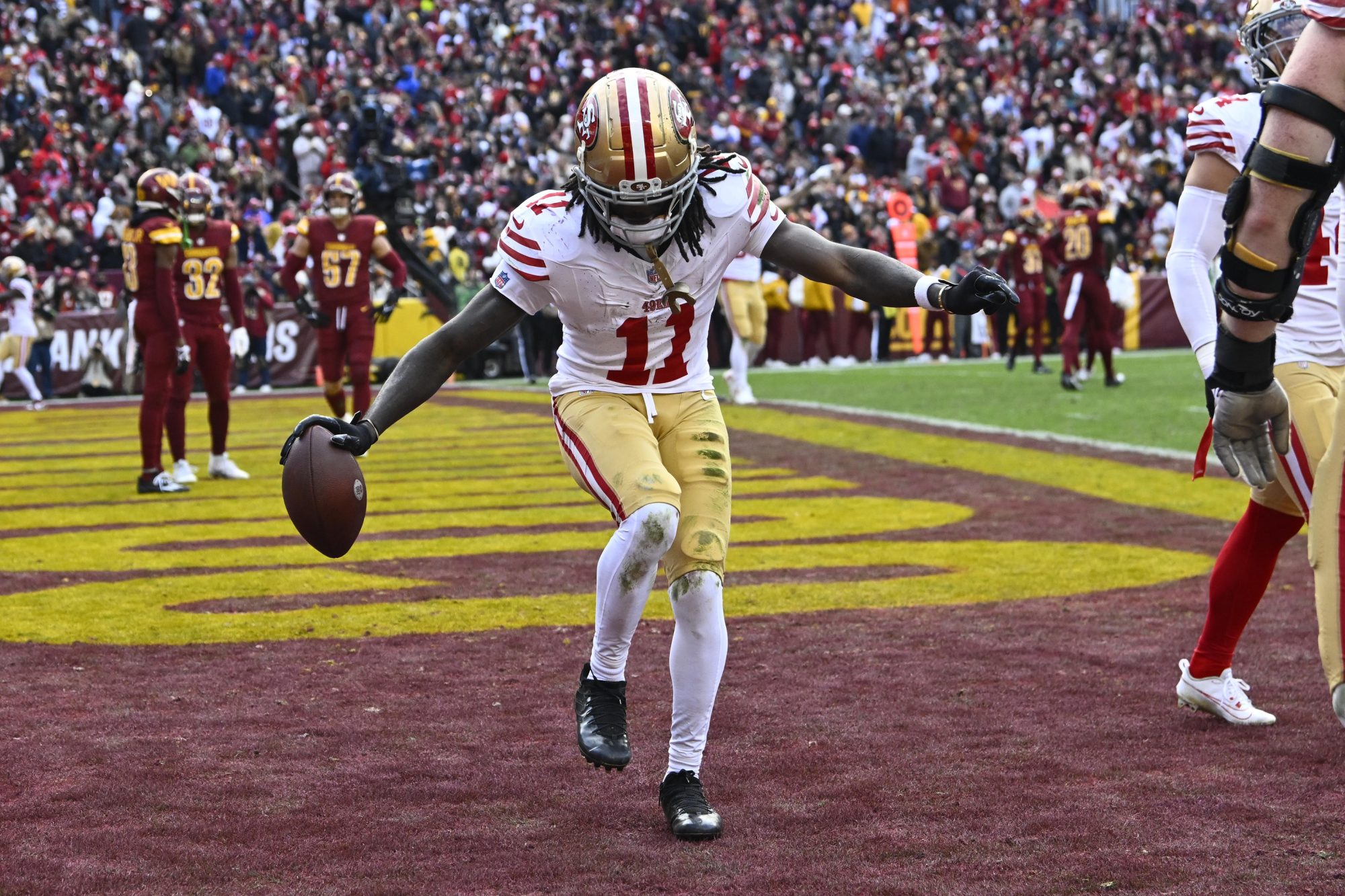 Dec 31, 2023; Landover, Maryland, USA; San Francisco 49ers wide receiver Brandon Aiyuk (11) celebrates after scoring a touchdown against the Washington Commanders during the second half at FedExField.