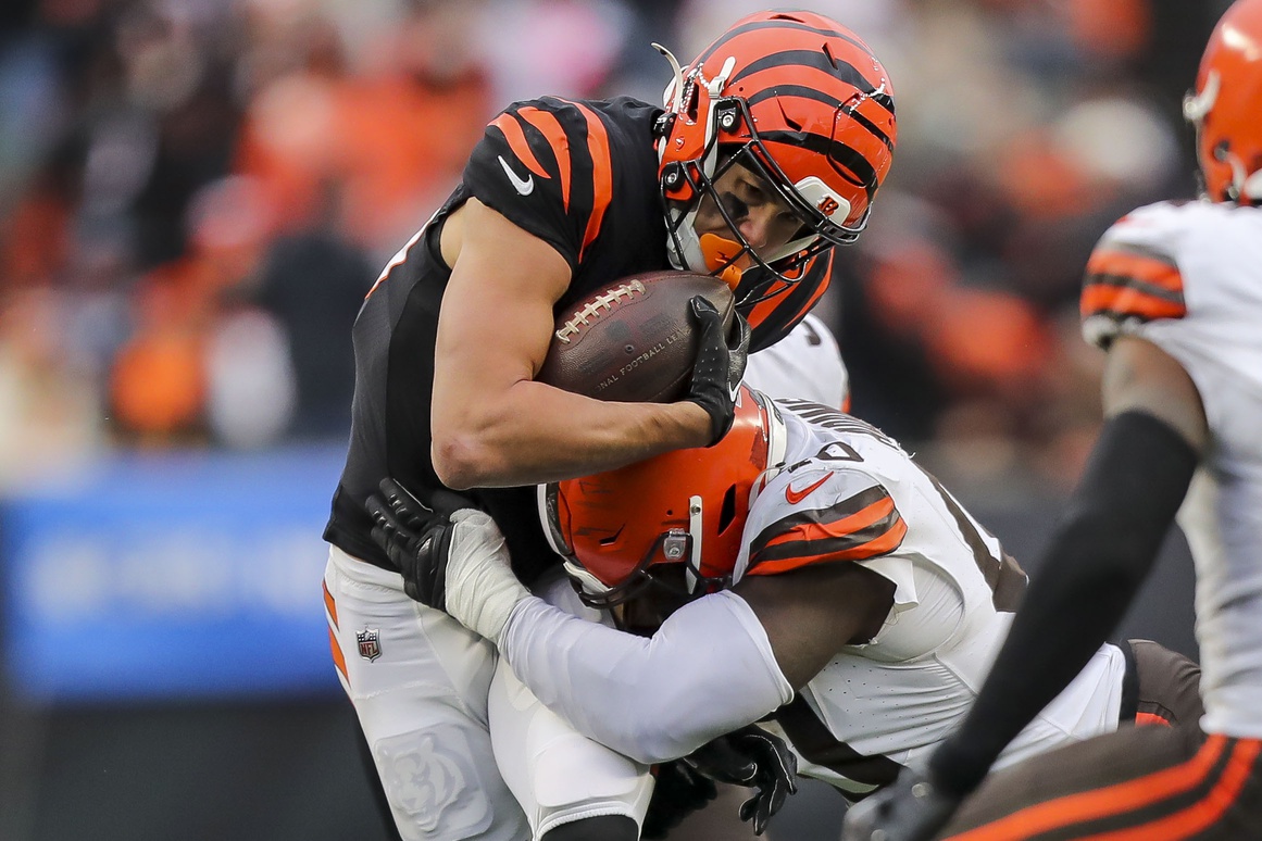 Jan 7, 2024; Cincinnati, Ohio, USA; Cincinnati Bengals wide receiver Andrei Iosivas (80) runs with the ball against Cleveland Browns linebacker Matthew Adams (40) in the second half at Paycor Stadium.