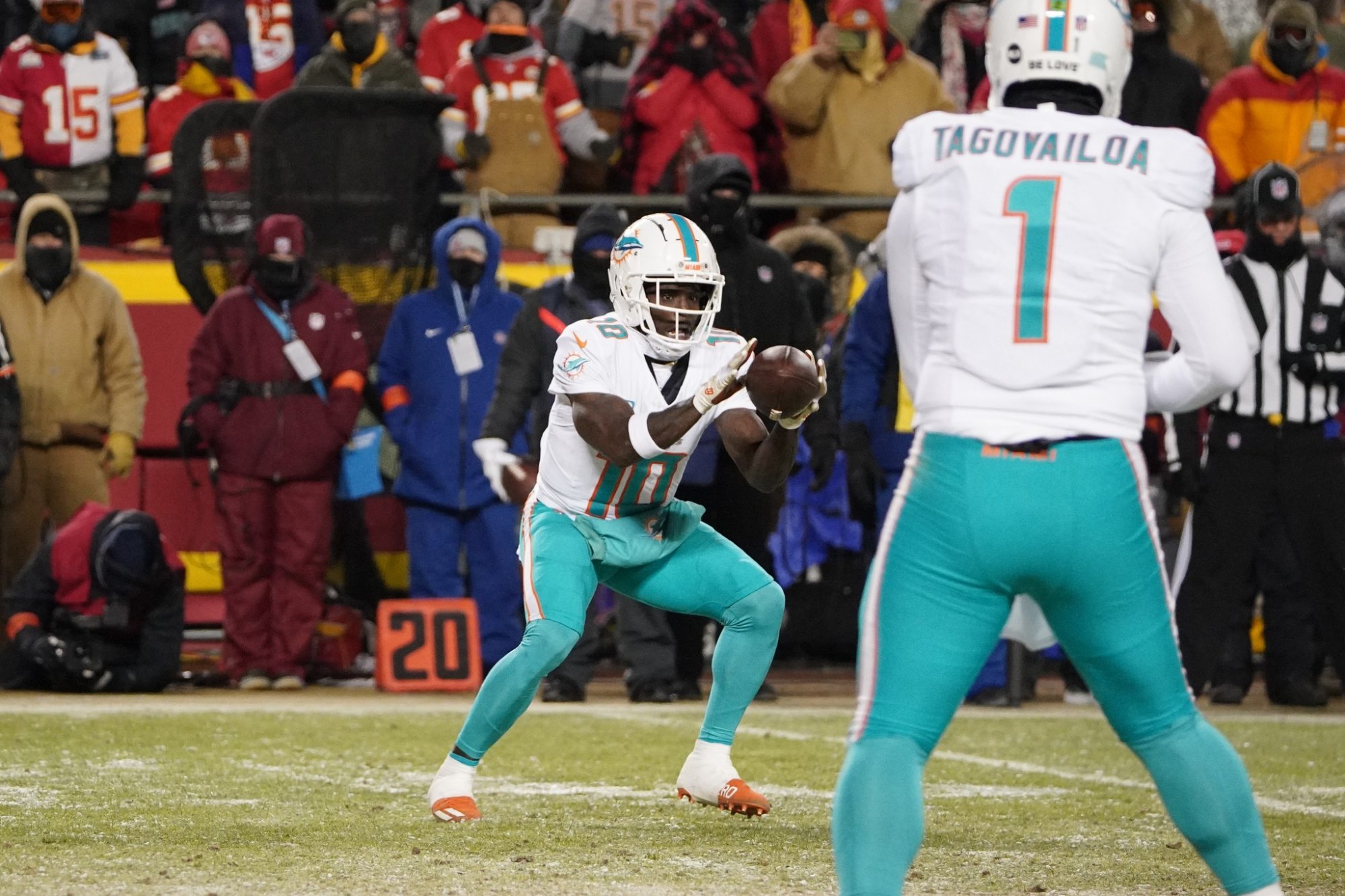 Jan 13, 2024; Kansas City, Missouri, USA; Miami Dolphins wide receiver Tyreek Hill (10) catches a pass from quarterback Tua Tagovailoa (1) during the first half of the 2024 AFC wild card game at GEHA Field at Arrowhead Stadium.