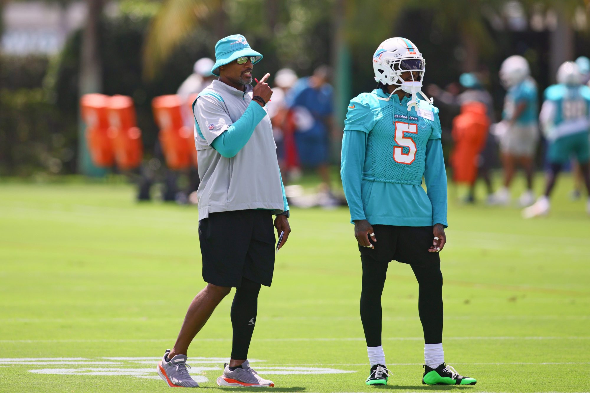 Jun 4, 2024; Miami Gardens, FL, USA; Miami Dolphins defensive coordinator Anthony Weaver talks to cornerback Jalen Ramsey (5) during mandatory minicamp at Baptist Health Training Complex.