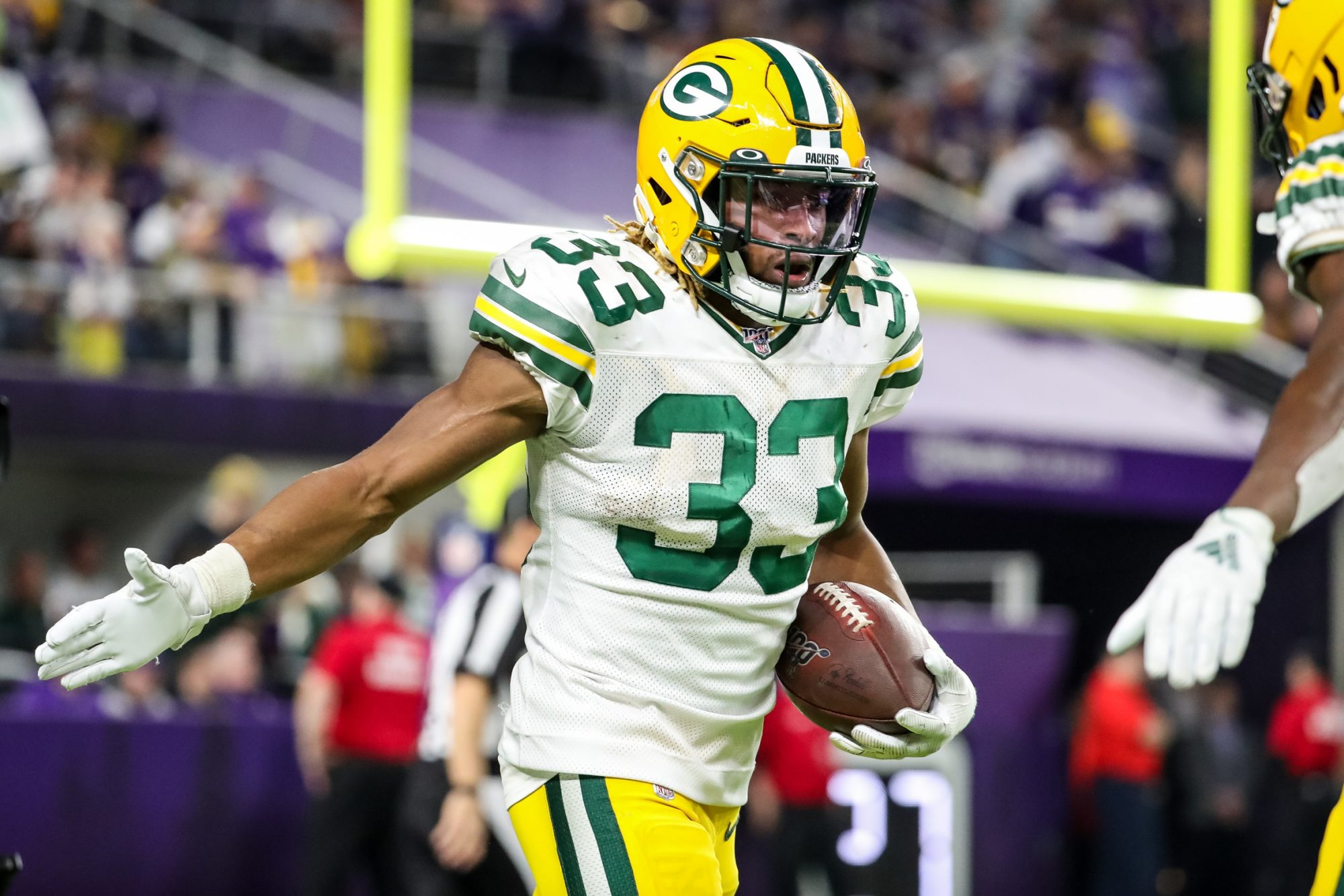 Dec 23, 2019; Minneapolis, Minnesota, USA; Green Bay Packers running back Aaron Jones (33) celebrates his touchdown during the fourth quarter against the Minnesota Vikings at U.S. Bank Stadium.