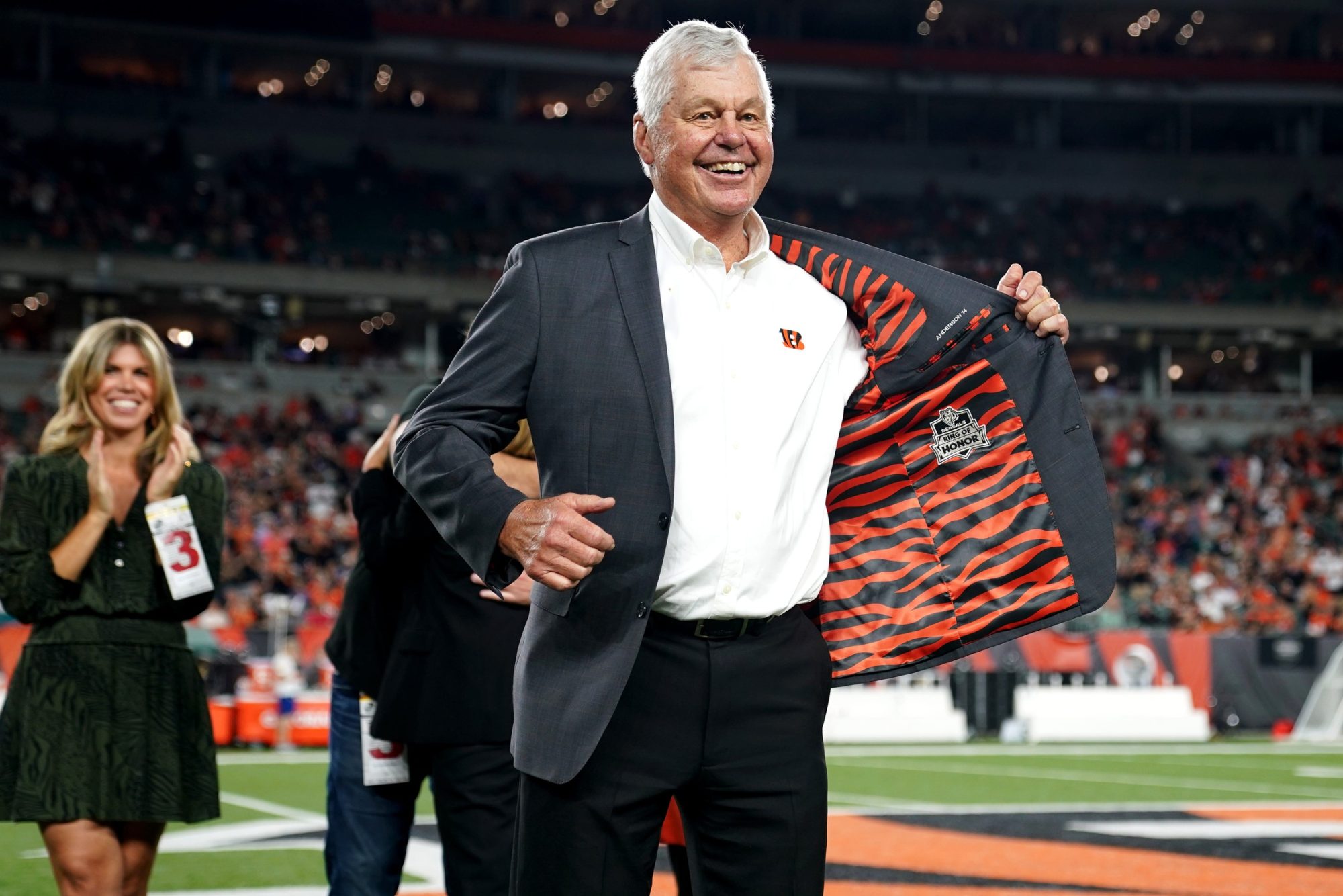 Former Cincinnati Bengals quarterback Ken Anderson displays the Ring of Honor insignia on the inside of his jacket during a halftime ceremony at halftime of a Week 4 NFL football game between the Jacksonville Jaguars and the Cincinnati Bengals, Thursday, Sept. 30, 2021, at Paul Brown Stadium in Cincinnati.