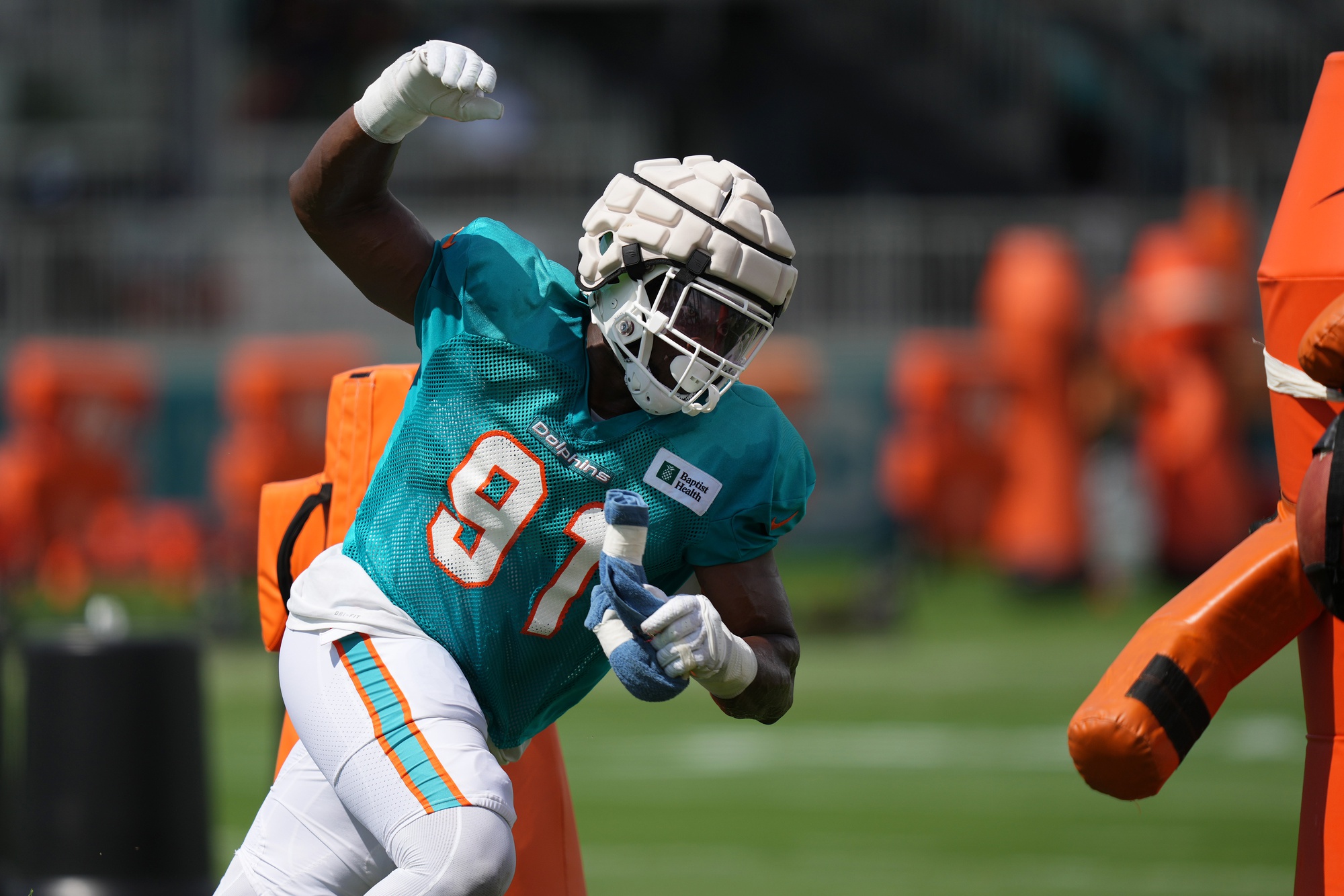 Aug 3, 2022; Miami Gardens, Florida, US; Miami Dolphins defensive end Emmanuel Ogbah (91) runs a drill during training camp at Baptist Health Training Complex.