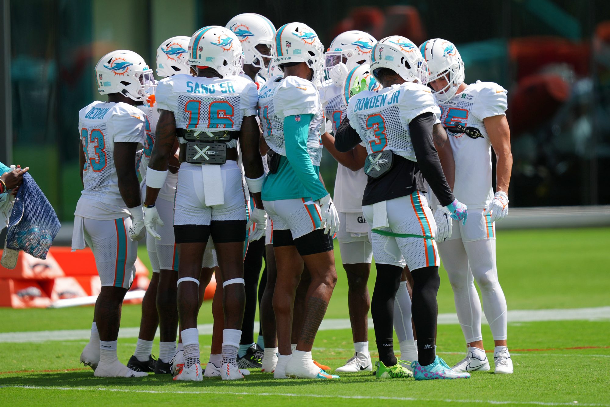 Aug 5, 2022; Miami Gardens, Florida, US; Miami Dolphins wide receivers huddle up on the field during training camp at Baptist Health Training Complex.