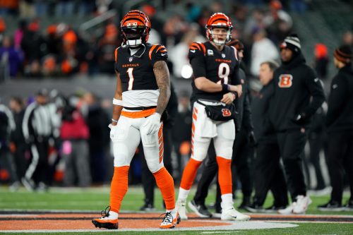 Cincinnati Bengals wide receiver Ja'Marr Chase (1) and Cincinnati Bengals quarterback Joe Burrow (9) warm up before an NFL wild-card playoff football game between the Baltimore Ravens and the Cincinnati Bengals, Sunday, Jan. 15, 2023, at Paycor Stadium in Cincinnati.