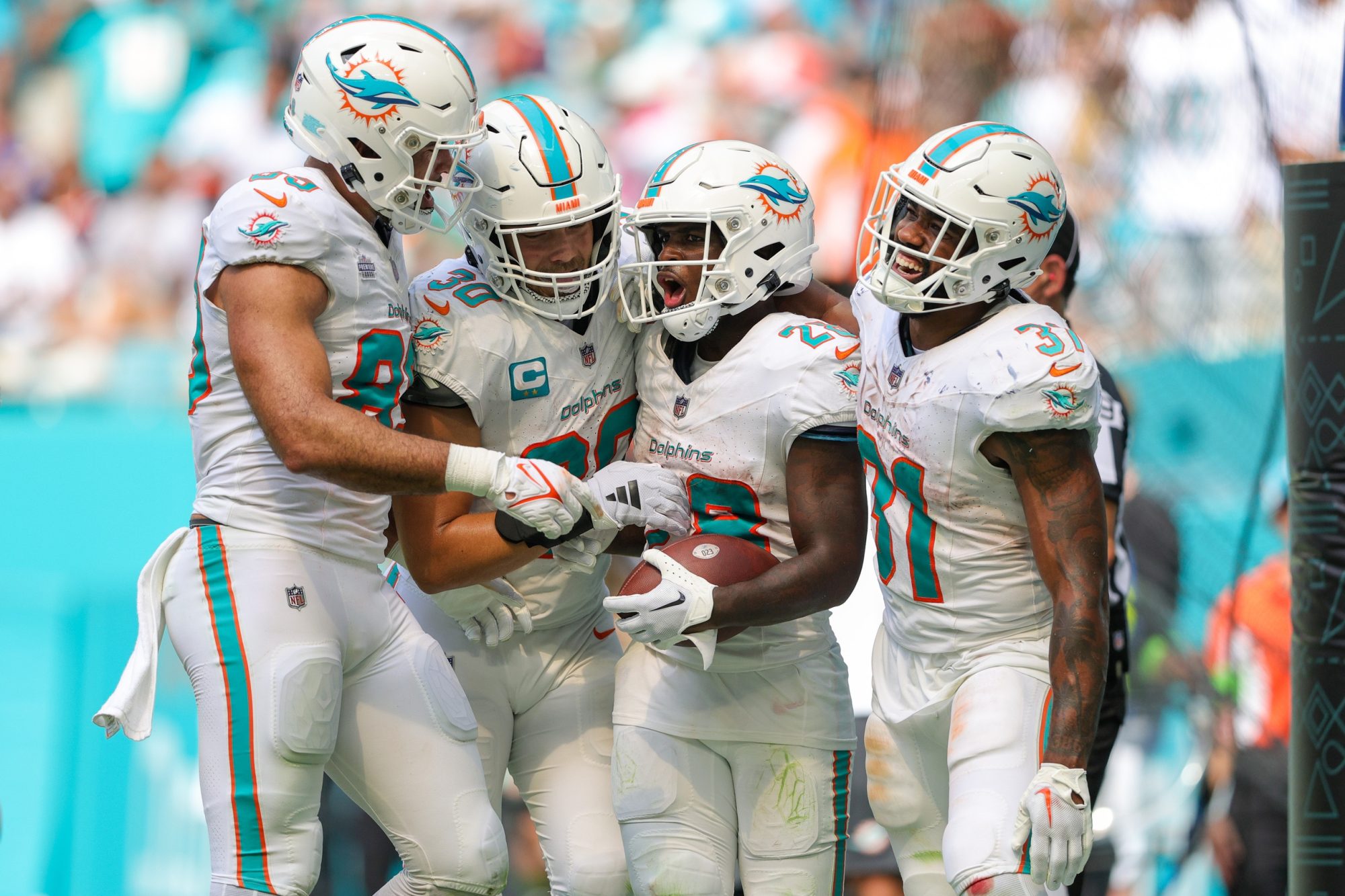 Sep 24, 2023; Miami Gardens, Florida, USA; Miami Dolphins running back De'Von Achane (28) celebrates his touchdown with Miami Dolphins running back Raheem Mostert (31) against the Denver Broncos in the fourth quarter at Hard Rock Stadium.