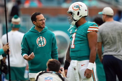 Dec 24, 2023; Miami Gardens, Florida, USA; Miami Dolphins head coach Mike McDaniel talks with quarterback Tua Tagovailoa (1) prior to the game against the Dallas Cowboys at Hard Rock Stadium.