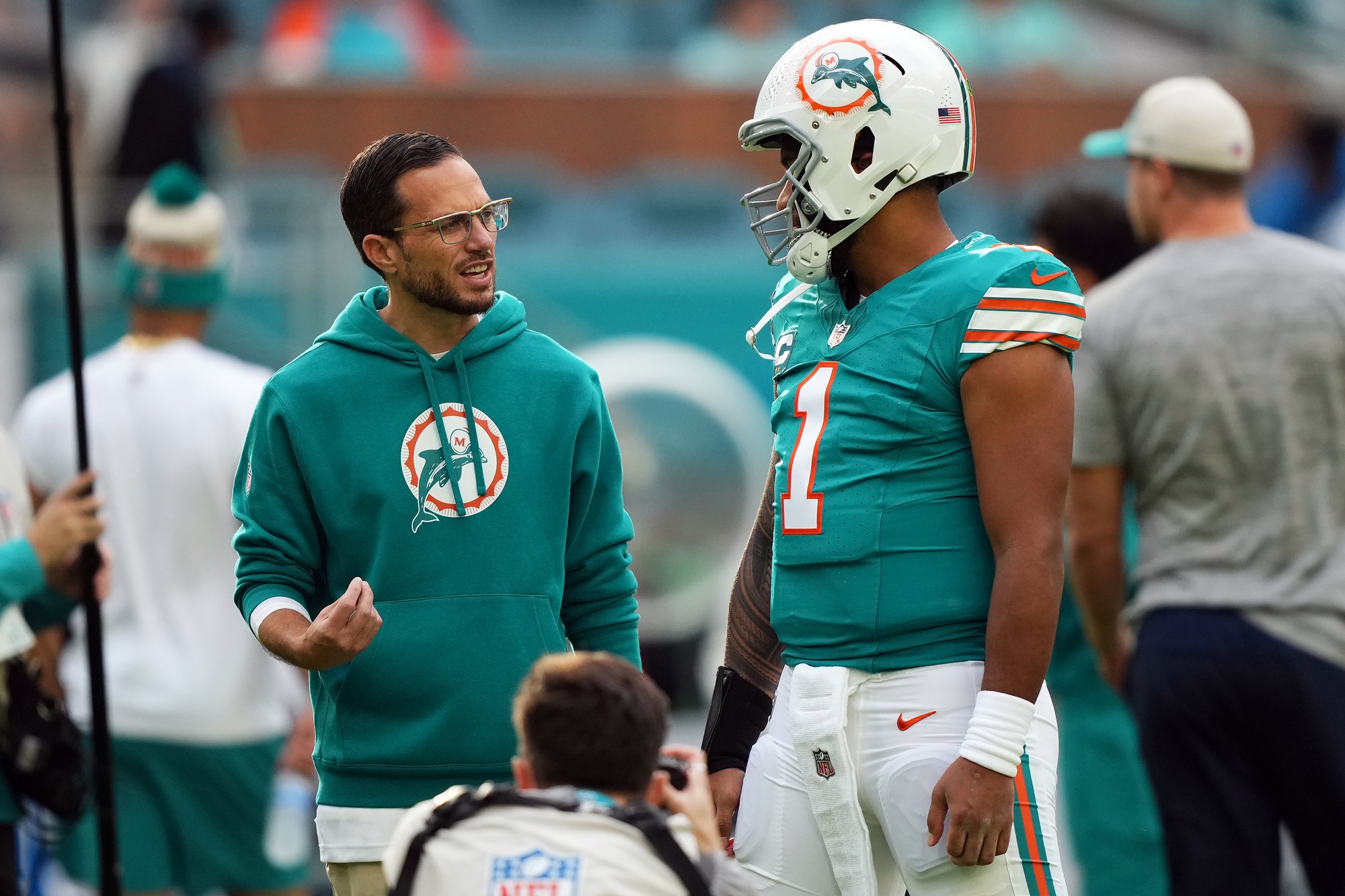 Dec 24, 2023; Miami Gardens, Florida, USA; Miami Dolphins head coach Mike McDaniel talks with quarterback Tua Tagovailoa (1) prior to the game against the Dallas Cowboys at Hard Rock Stadium.