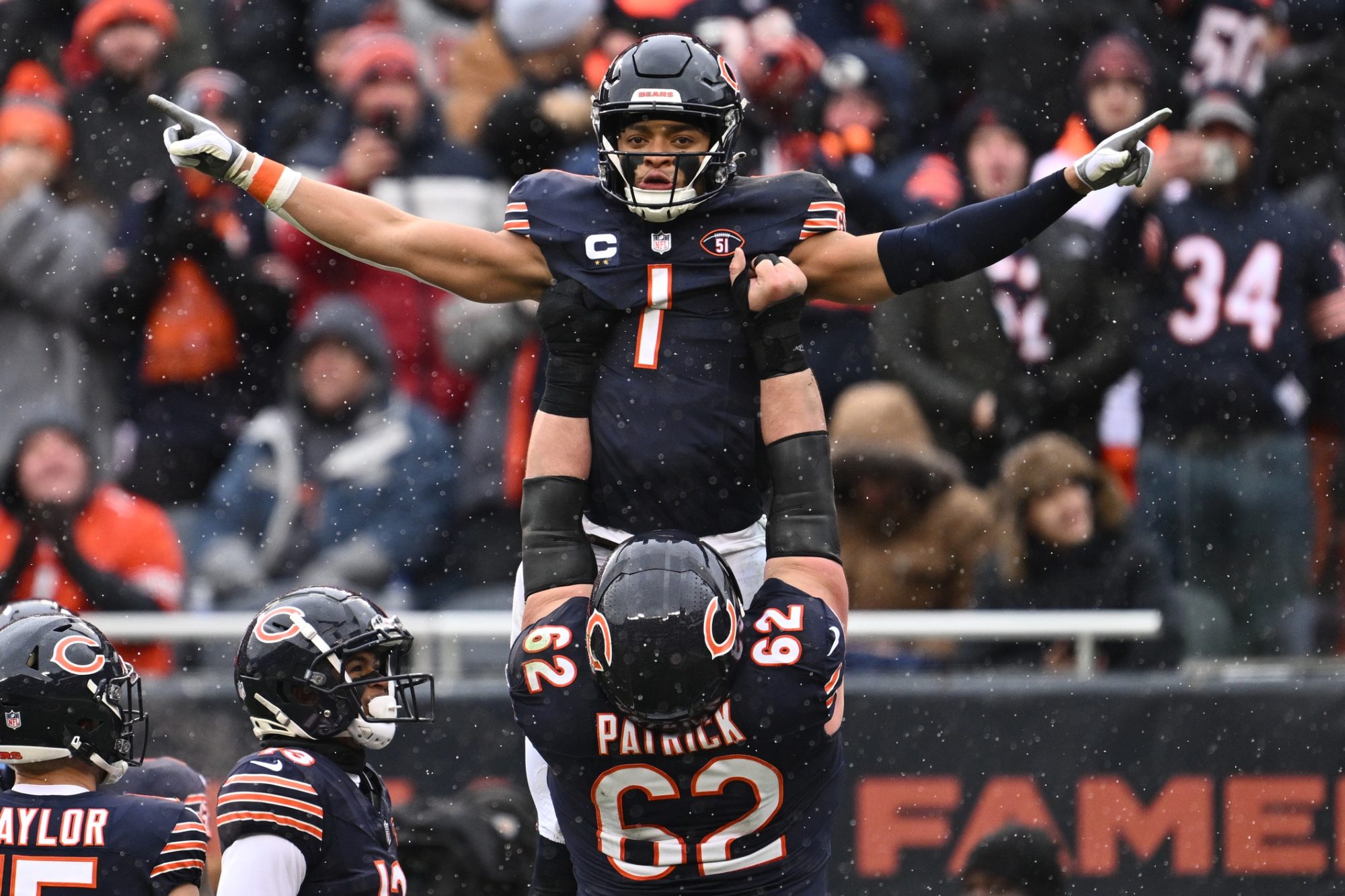 Dec 31, 2023; Chicago, Illinois, USA; Chicago Bears quarterback Justin Fields (1) celebrates with offensive lineman Lucas Patrick (62) after running for a 9-yard touchdown in the first half against the Atlanta Falcons at Soldier Field.