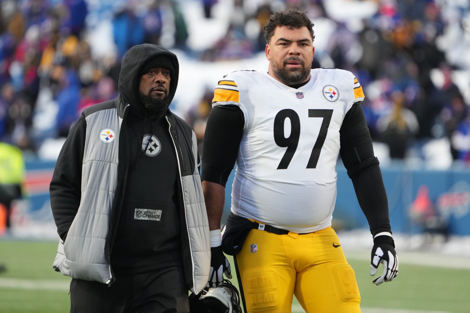 Jan 15, 2024; Orchard Park, New York, USA; Pittsburgh Steelers head coach Mike Tomlin walks the field with defensive tackle Cameron Heyward (97) before the game against the Buffalo Bills in a 2024 AFC wild card game at Highmark Stadium.