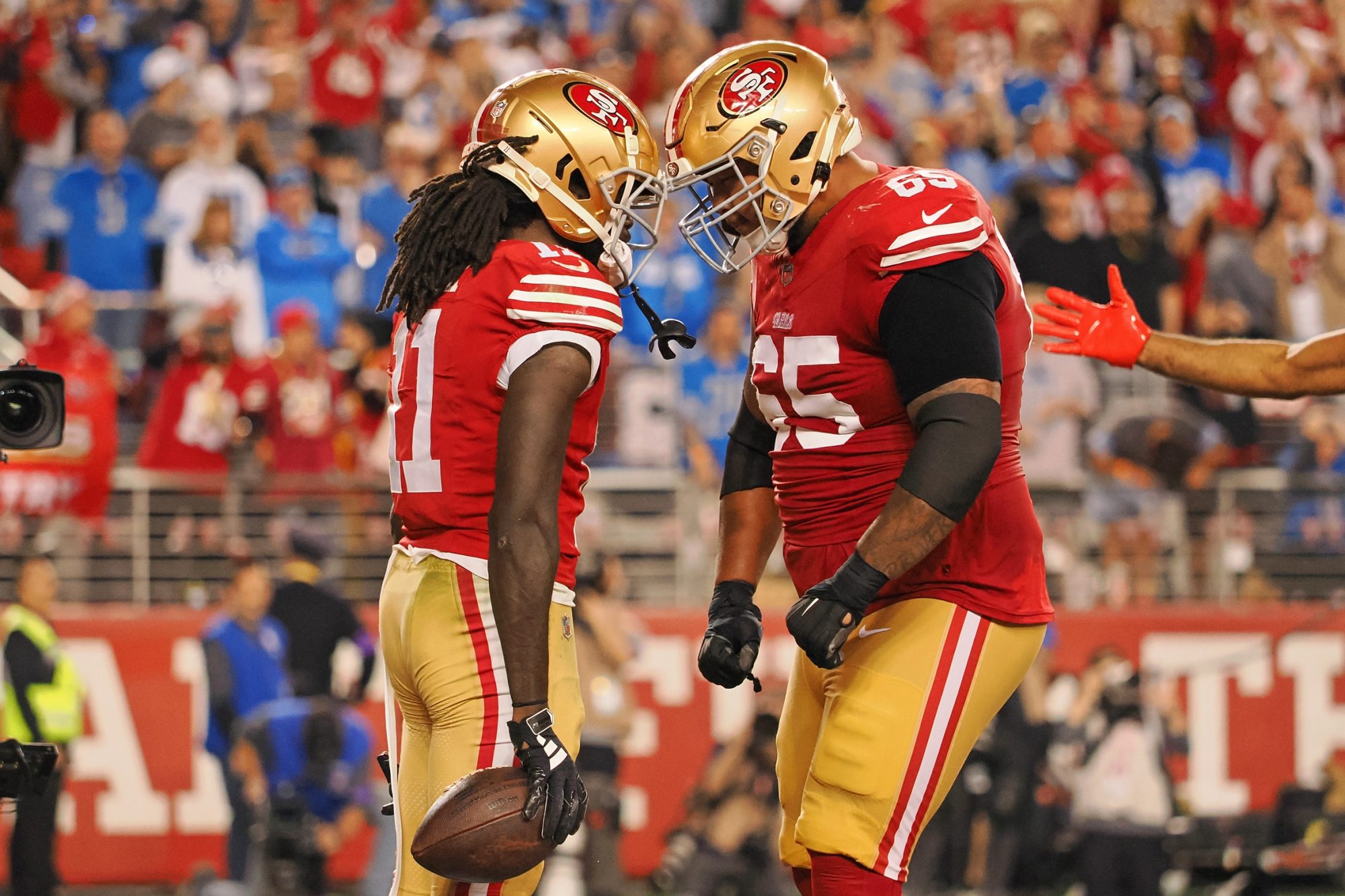 Jan 28, 2024; Santa Clara, California, USA; San Francisco 49ers wide receiver Brandon Aiyuk (11) celebrates with guard Aaron Banks (65) after scoring a touchdown against the Detroit Lions during the second half of the NFC Championship football game at Levi's Stadium.