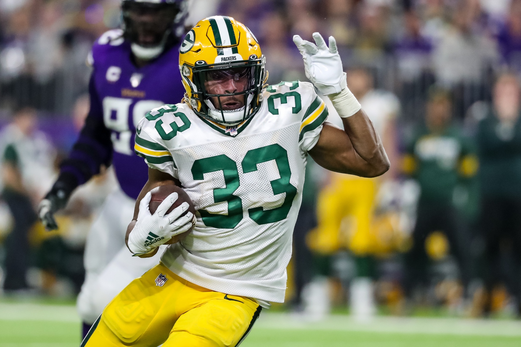 Dec 23, 2019; Minneapolis, Minnesota, USA; Green Bay Packers running back Aaron Jones (33) carries the ball during the second quarter against the Minnesota Vikings at U.S. Bank Stadium.