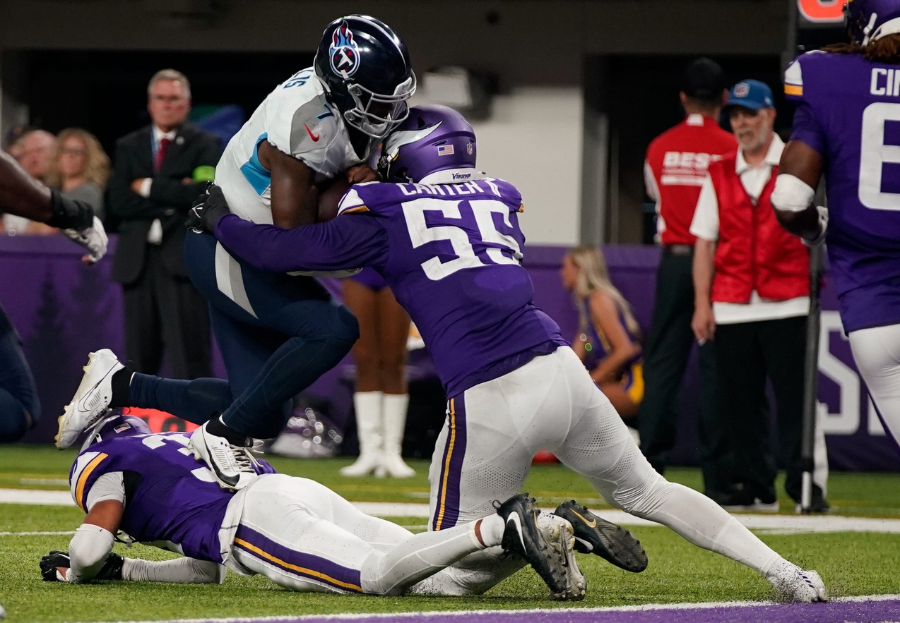 Tennessee Titans quarterback Malik Willis (7) is stopped by Minnesota Vikings linebacker Andre Carter II (55) just short of the end zone at U.S. Bank Stadium in Minneapolis, Minn., Saturday, Aug. 19, 2023.