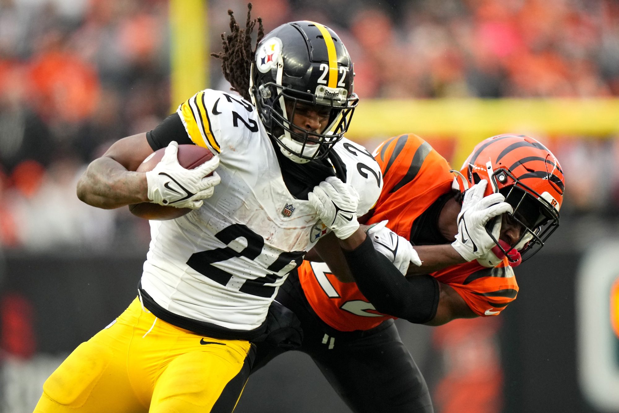 Nov 26, 2023; Cincinnati, Ohio, USA; Pittsburgh Steelers running back Najee Harris (22) stiff arms Cincinnati Bengals cornerback Chidobe Awuzie (22) on a carry in the fourth quarter at Paycor Stadium.