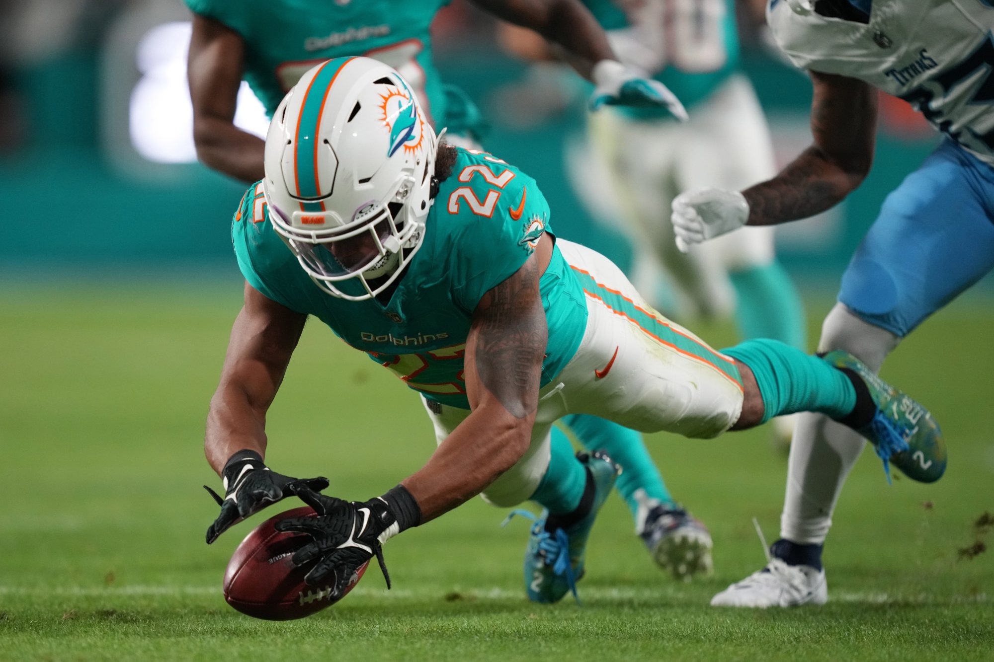 Miami Dolphins safety Elijah Campbell (22) recovers a muffed punt against the Tennessee Titans during the second half of an NFL game at Hard Rock Stadium in Miami Gardens, Dec. 11, 2023.