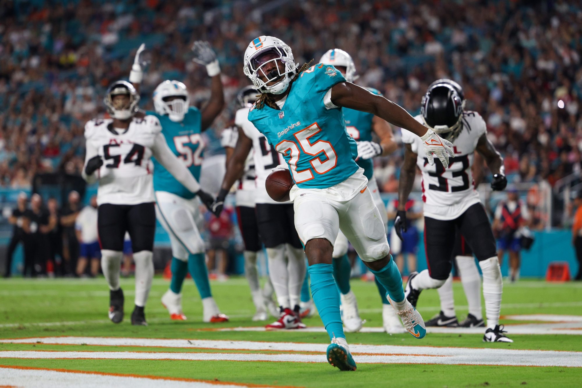 Aug 9, 2024; Miami Gardens, Florida, USA; Miami Dolphins running back Jaylen Wright (25) celebrates after scoring a touchdown against the Atlanta Falcons in the second quarter during preseason at Hard Rock Stadium.