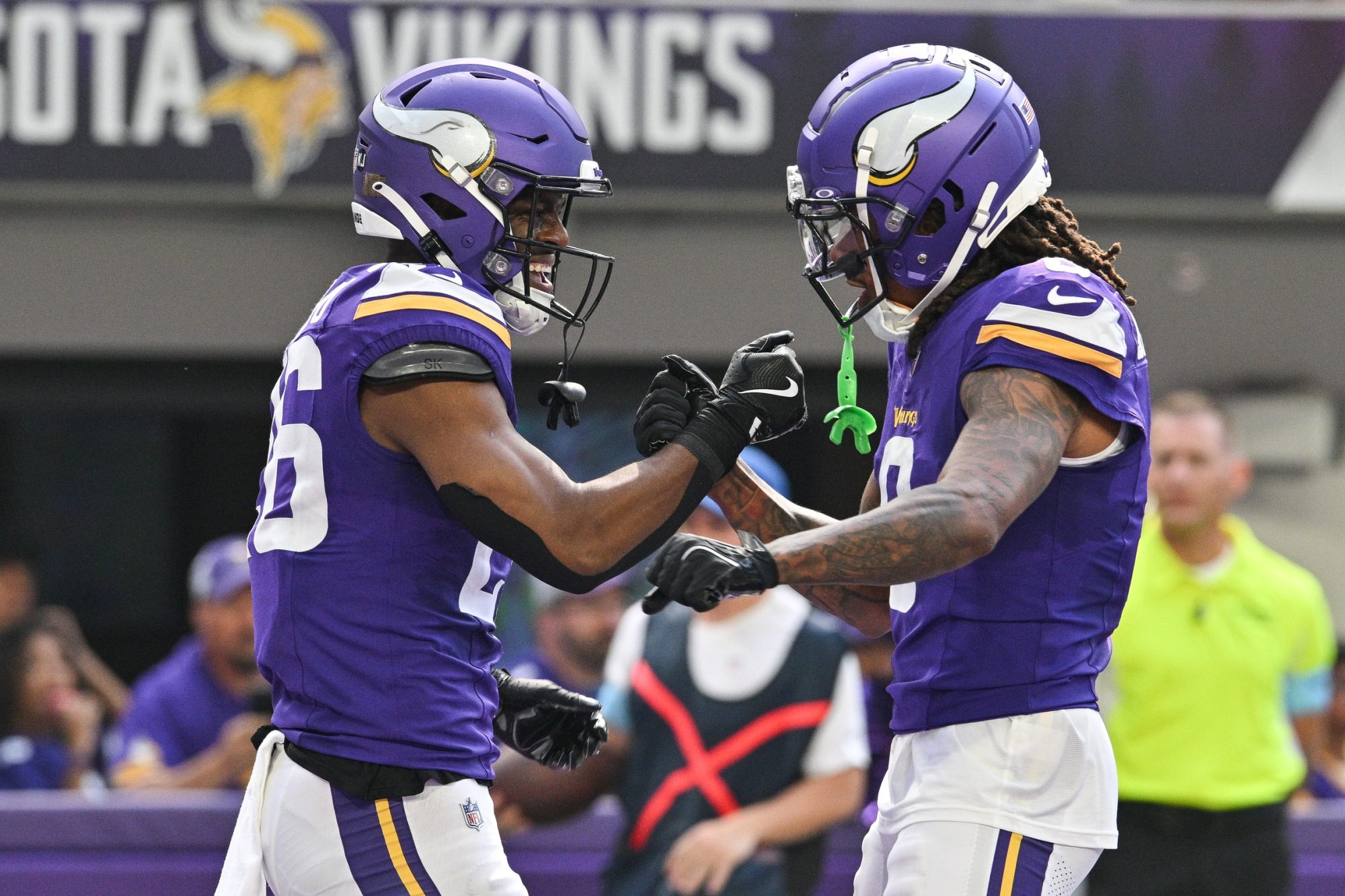 Aug 10, 2024; Minneapolis, Minnesota, USA; Minnesota Vikings running back Kene Nwangwu (26) reacts with wide receiver Trishton Jackson (8) after running for a touchdown against the Las Vegas Raiders during the second quarter at U.S. Bank Stadium.