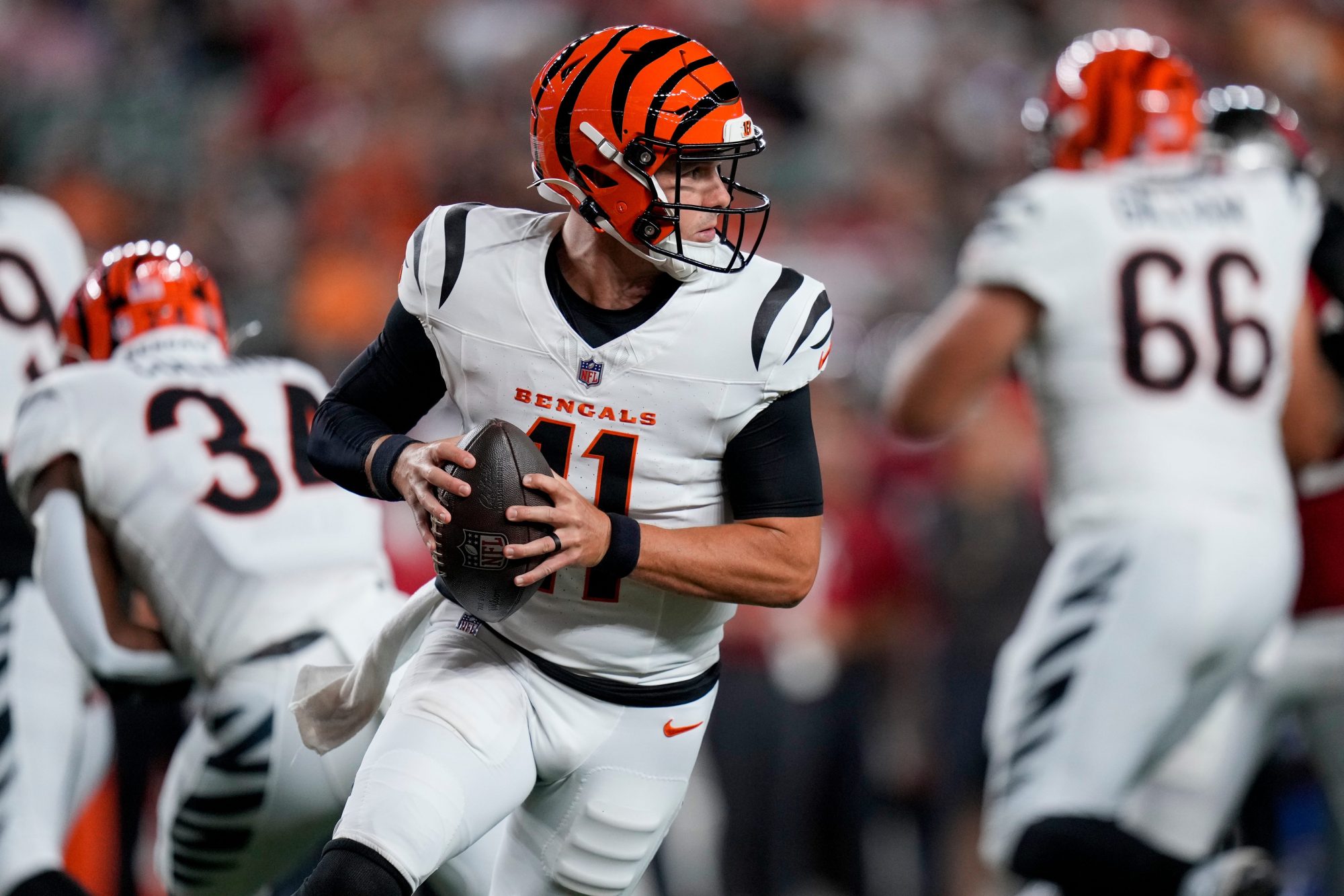 Cincinnati Bengals quarterback Logan Woodside (11) rolls out in the fourth quarter of the NFL Preseason Week 1 game between the Cincinnati Bengals and the Tampa Bay Buccaneers at Paycor Stadium in downtown Cincinnati on Saturday, Aug. 10, 2024. The Tampa Bay Buccaneers beat the Bengals 17-14.