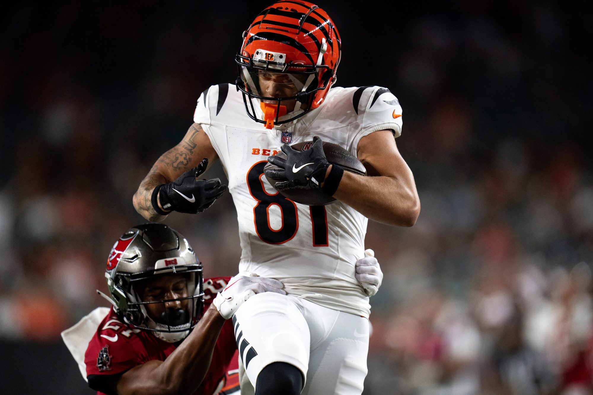 Cincinnati Bengals wide receiver Jermaine Burton (81) catches a pass for a touchdown as Tampa Bay Buccaneers corner back Zyon McCollum (27) attempts to stop him in the fourth quarter of the NFL preseason game at Paycor Stadium in Cincinnati on Saturday, August 10, 2024.