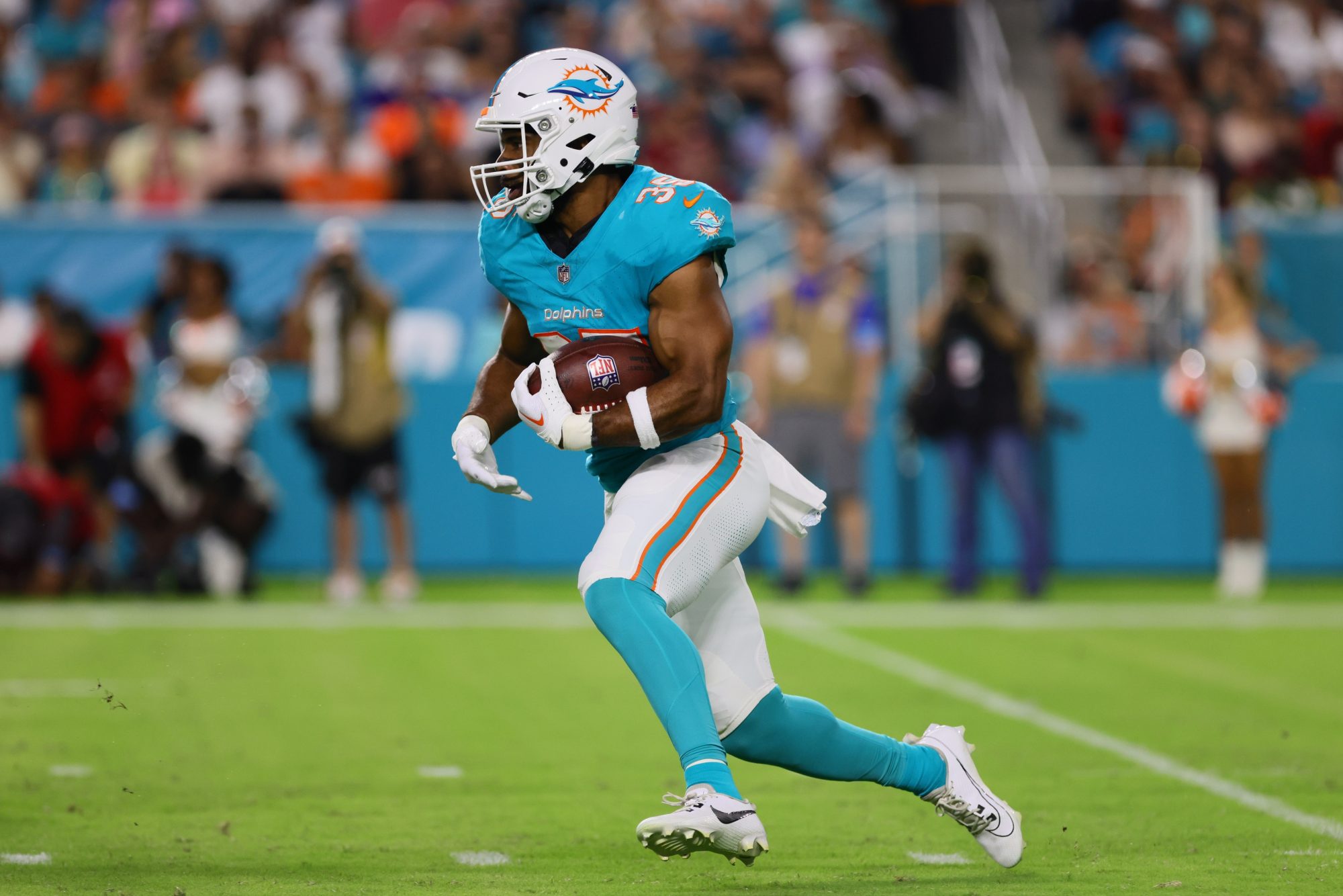 Aug 17, 2024; Miami Gardens, Florida, USA; Miami Dolphins running back Chris Brooks (35) runs with the football against the Washington Commanders during the second quarter of a preseason game at Hard Rock Stadium.