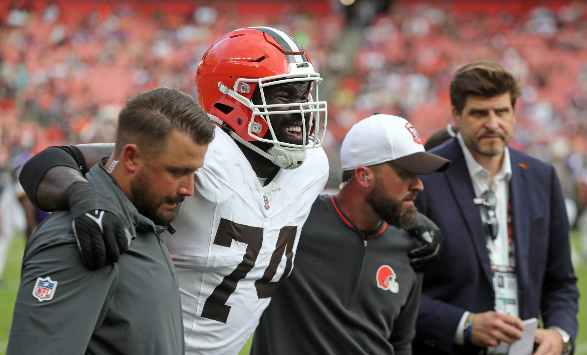 Cleveland Browns offensive tackle Hakeem Adeniji (74) is helped off the field during the second half of an NFL preseason football game at Cleveland Browns Stadium, Saturday, Aug. 17, 2024, in Cleveland, Ohio.