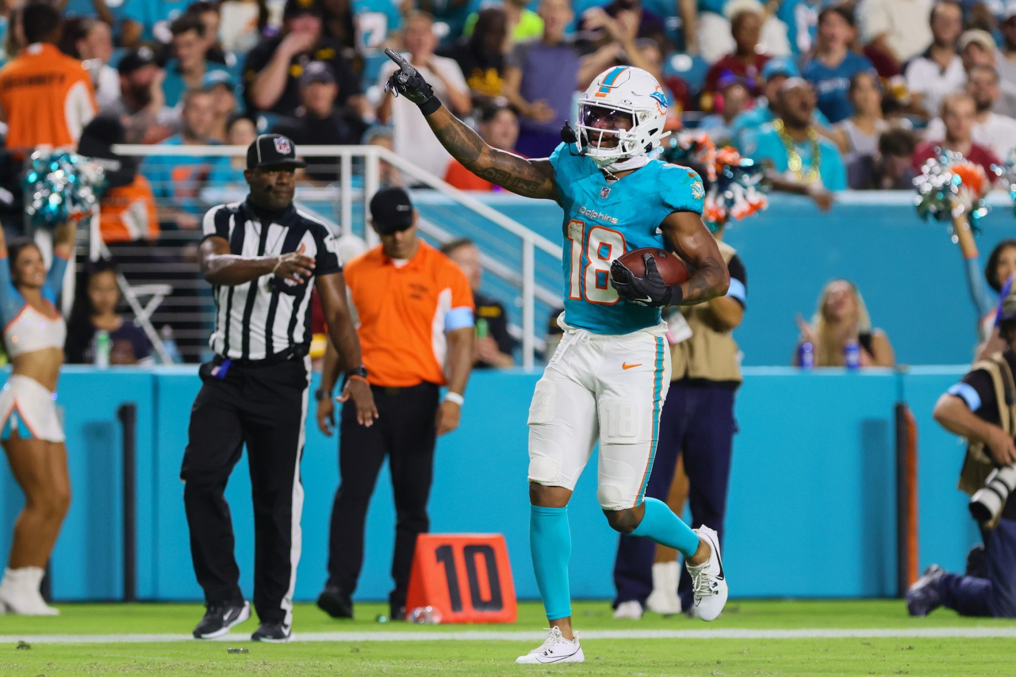 Aug 17, 2024; Miami Gardens, Florida, USA; Miami Dolphins wide receiver Erik Ezukanma (18) reacts after catching the football against the Washington Commanders during the third quarter of a preseason game at Hard Rock Stadium.