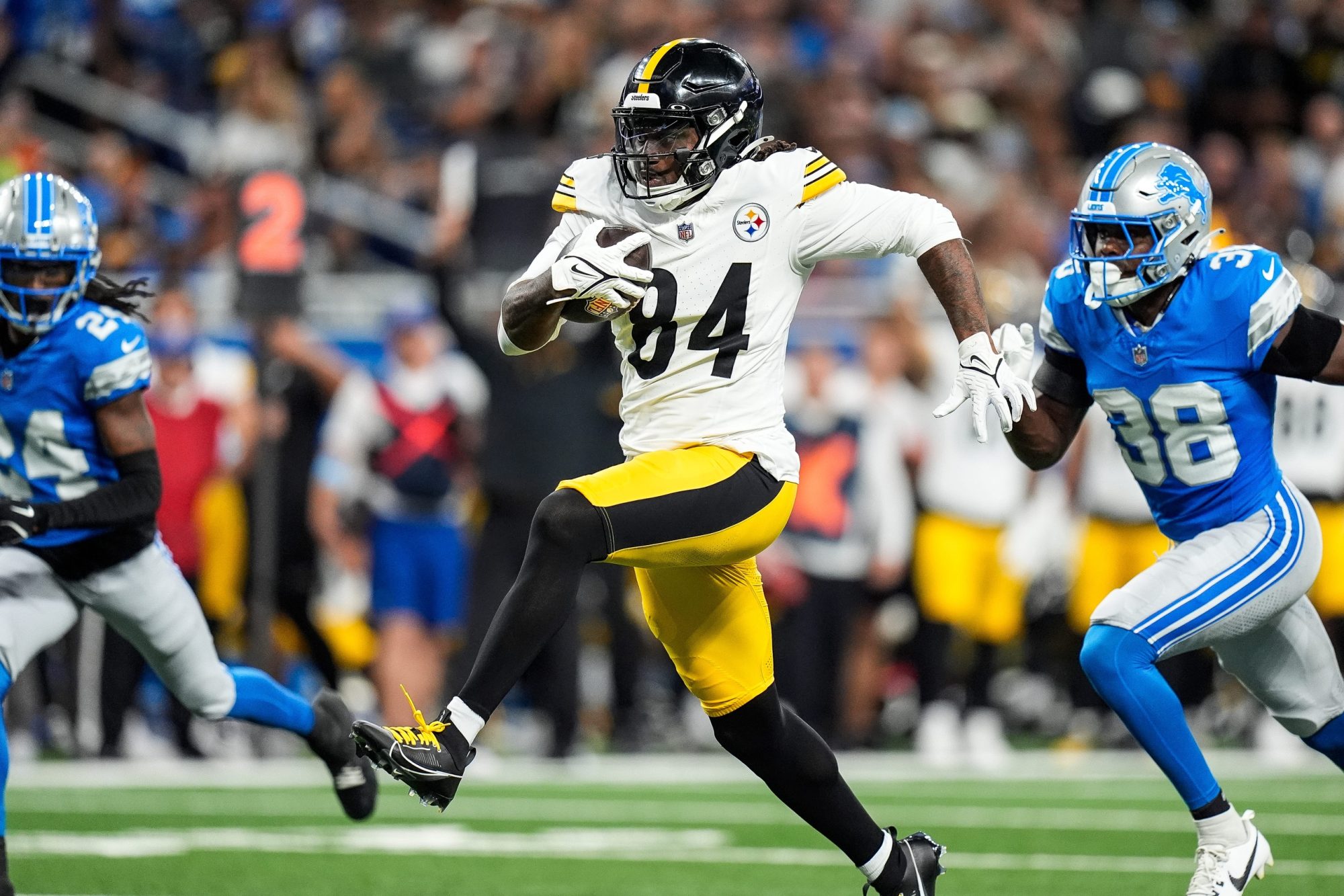 Pittsburgh Steelers running back Cordarrelle Patterson (84) runs for a touchdown against Detroit Lions cornerback Steven Gilmore (24) and safety C.J. Moore (38) during the first half of a preseason game at Ford Field in Detroit on Saturday, August 24, 2024.