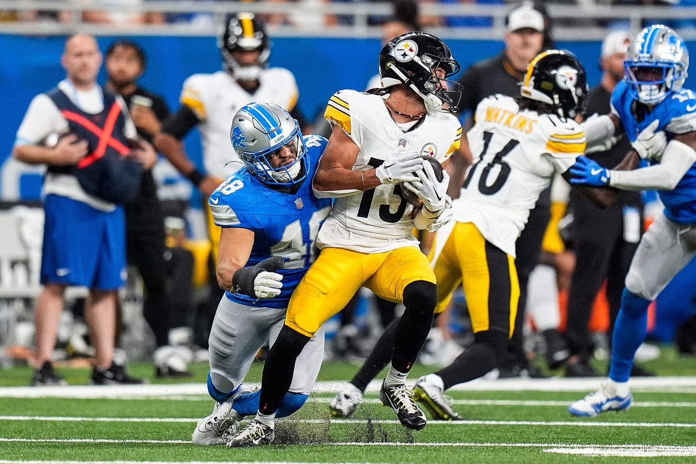 Detroit Lions safety Loren Strickland (48) tackles Pittsburgh Steelers wide receiver Scotty Miller (13) during the first half of a preseason game at Ford Field in Detroit on Saturday, August 24, 2024.