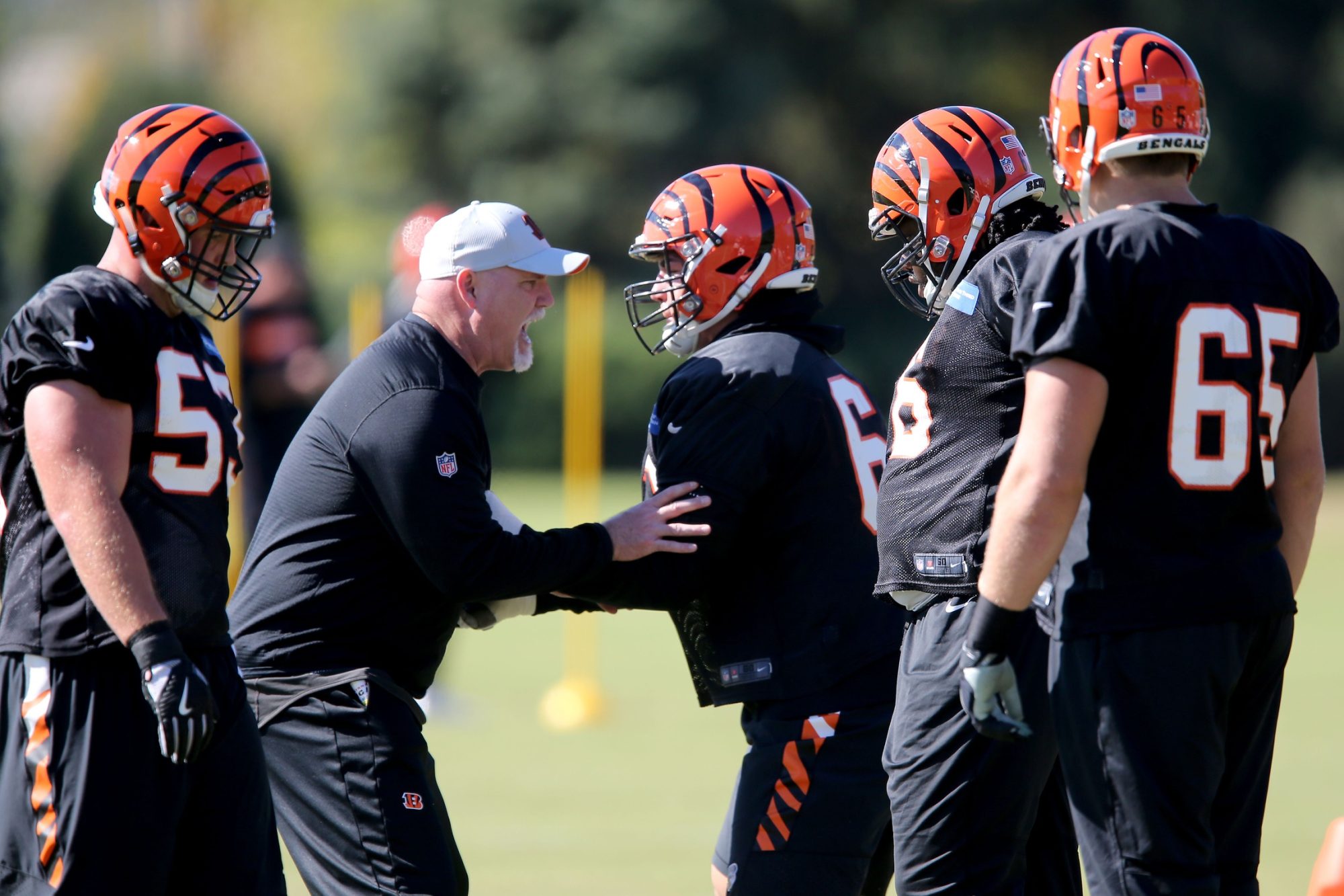 Cincinnati Bengals offensive line coach Frank Pollack works with Cincinnati Bengals offensive guard Alex Redmond (62) during practice, Wednesday, Oct. 24, 2018, on the practice fields next to Paul Brown Stadium in Cincinnati.