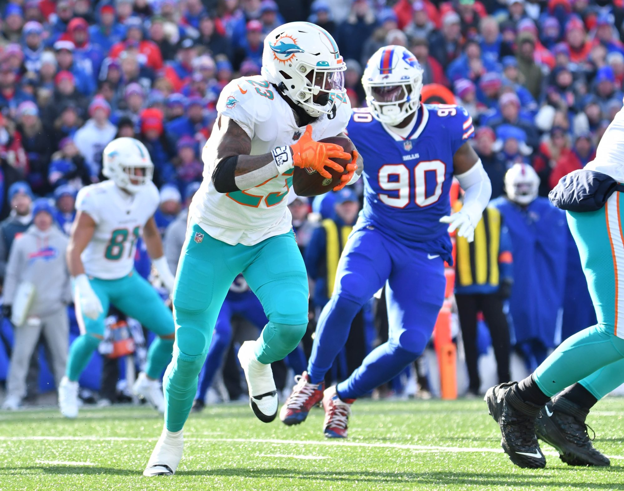 Jan 15, 2023; Orchard Park, NY, USA; Miami Dolphins running back Jeff Wilson Jr. (23) runs the ball against the Buffalo Bills during the first half in a NFL wild card game at Highmark Stadium.