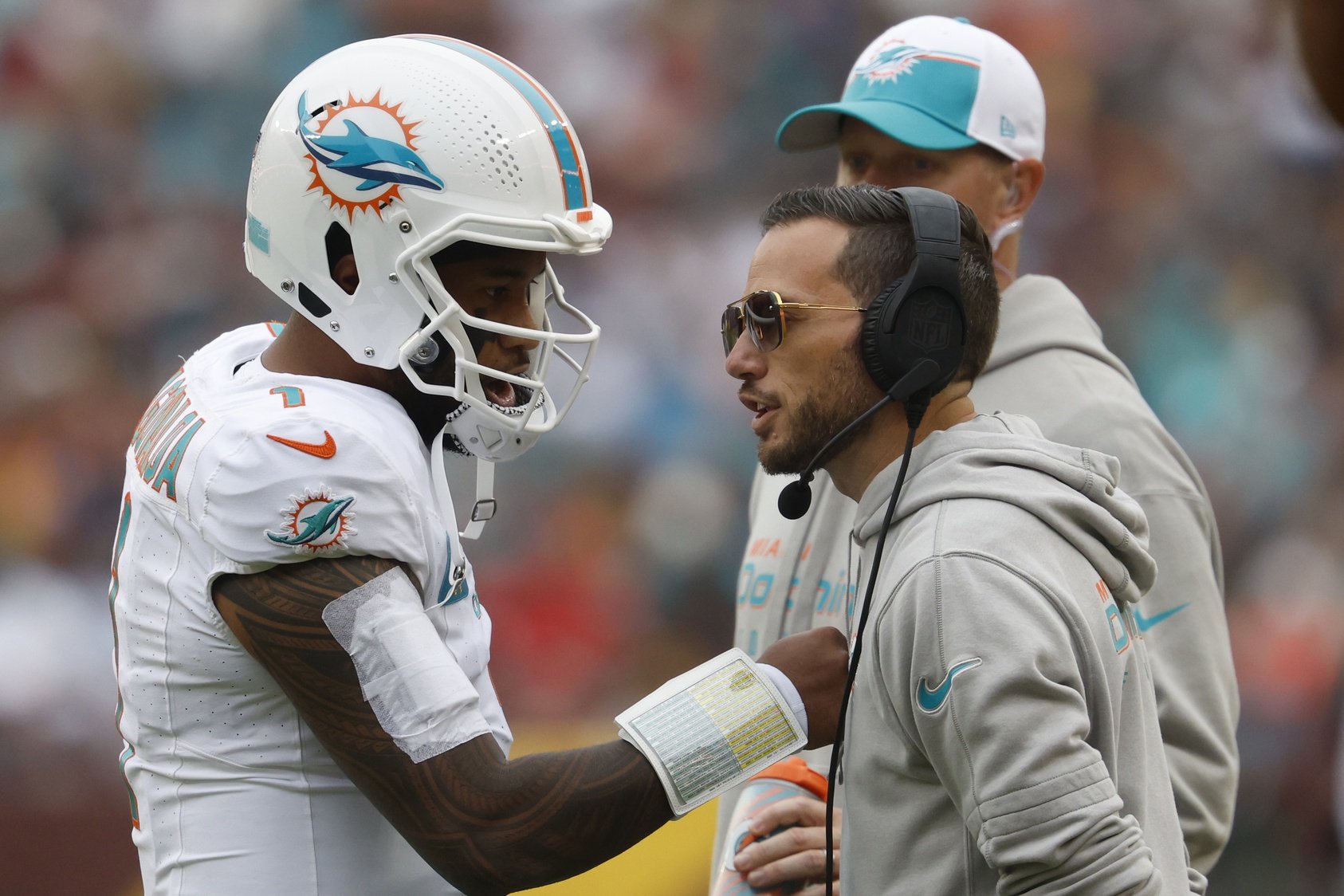 Dec 3, 2023; Landover, Maryland, USA; Miami Dolphins quarterback Tua Tagovailoa (1) talks with Dolphins head coach Mike McDaniel (R) during a timeout against the Washington Commanders during the second quarter at FedExField.