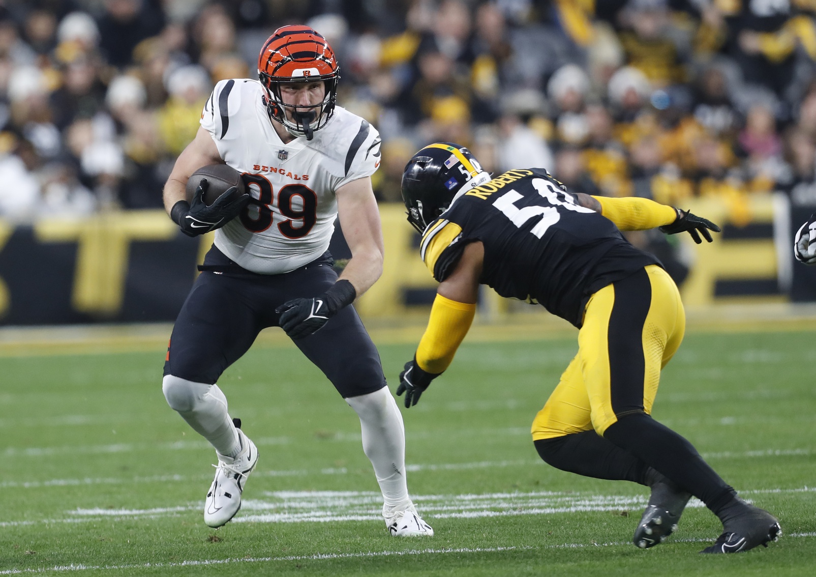 Dec 23, 2023; Pittsburgh, Pennsylvania, USA; Cincinnati Bengals tight end Drew Sample (89) runs after a catch as Pittsburgh Steelers linebacker Elandon Roberts (50) defends during the first quarter at Acrisure Stadium.