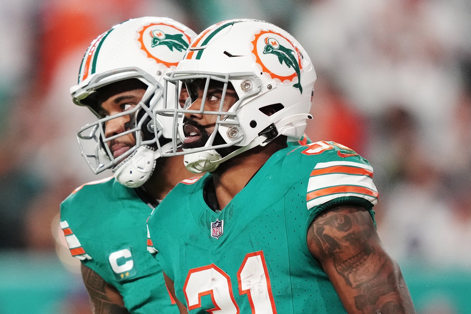 Miami Dolphins quarterback Tua Tagovailoa (1) congratulates running back Raheem Mostert (31) after scoring a touchdown against the Dallas Cowboys during the first half of an NFL game at Hard Rock Stadium in Miami Gardens, Dec. 24, 2023.