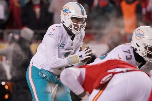 Jan 13, 2024; Kansas City, Missouri, USA; Miami Dolphins quarterback Tua Tagovailoa (1) before taking the snap against the Kansas City Chiefs during the second half of the 2024 AFC wild card game at GEHA Field at Arrowhead Stadium.