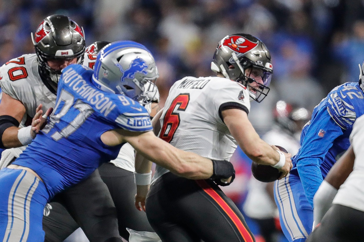 Detroit Lions defensive end Aidan Hutchinson (97) tackles Tampa Bay Buccaneers quarterback Baker Mayfield (6) during the second half of the NFC divisional round at Ford Field in Detroit on Sunday, Jan. 21, 2024.