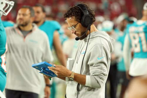 Aug 23, 2024; Tampa, Florida, USA; Miami Dolphins head coach Mike McDaniel looks down against the Tampa Bay Buccaneers during the second half at Raymond James Stadium.