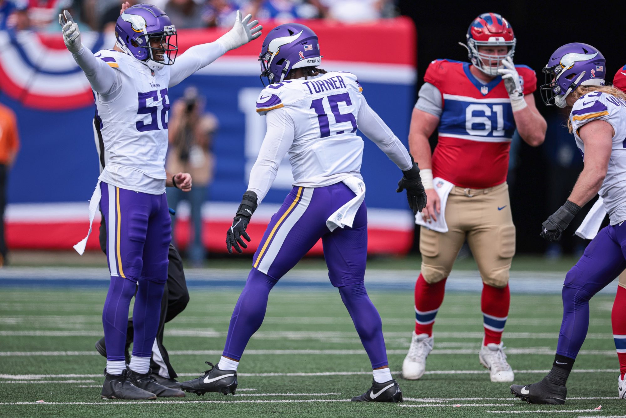 Sep 8, 2024; East Rutherford, New Jersey, USA; Minnesota Vikings linebacker Jonathan Greenard (58) celebrates a sack with linebacker Dallas Turner (15) during the first half against the New York Giants at MetLife Stadium.