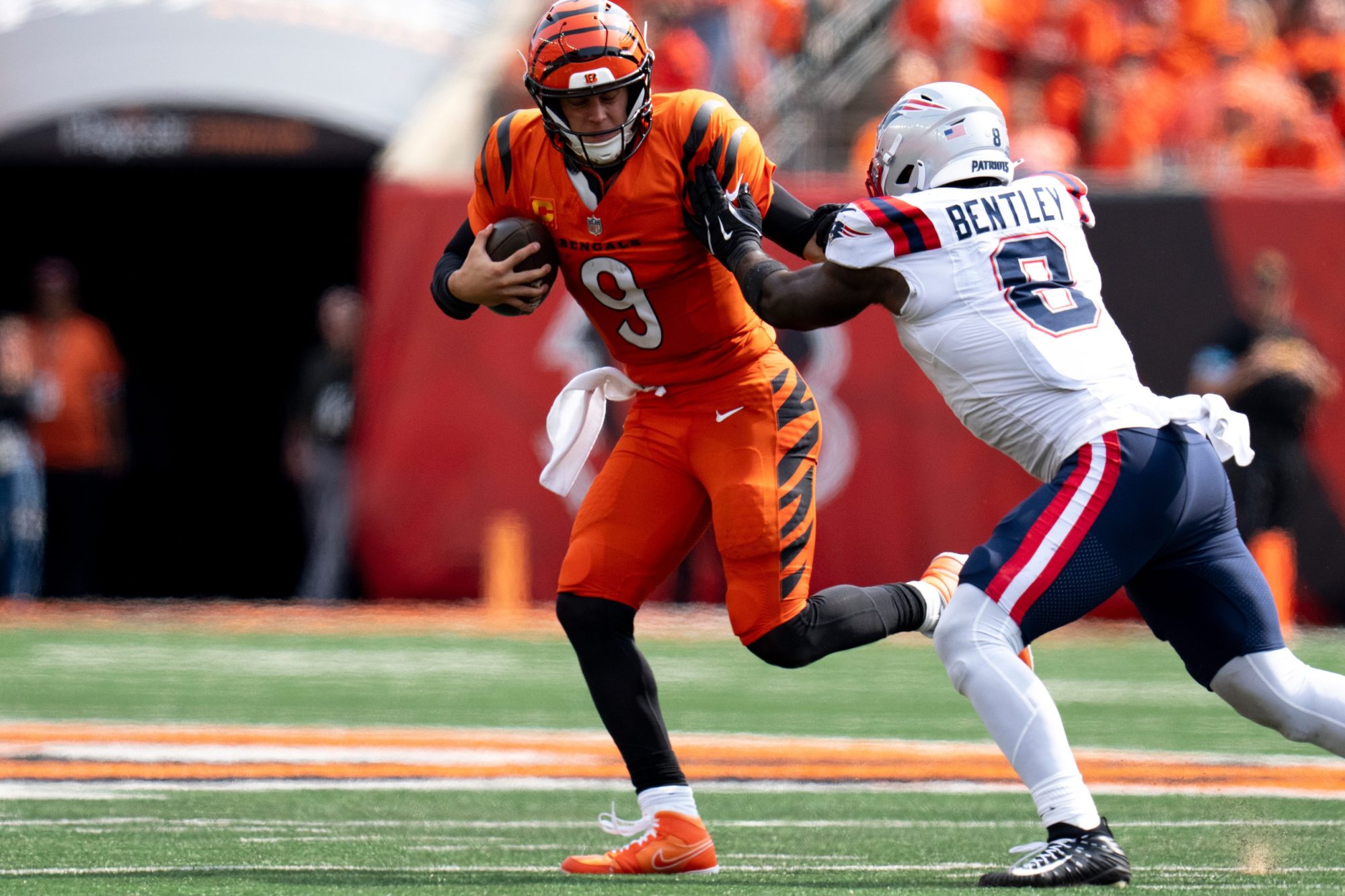 New England Patriots linebacker Ja'Whaun Bentley (8) tackles Cincinnati Bengals quarterback Joe Burrow (9) in the fourth quarter of the NFL game at Paycor Stadium in Cincinnati on Sunday, Sept. 8, 2024.