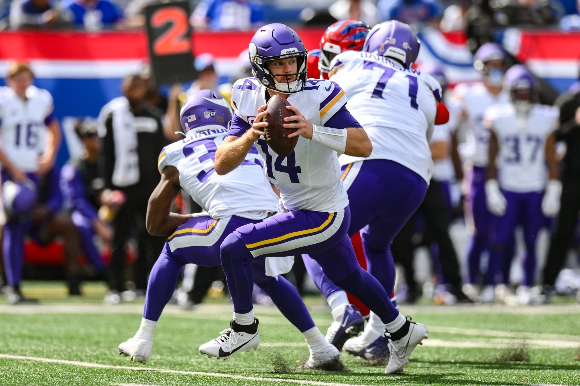 Sep 8, 2024; East Rutherford, New Jersey, USA; Minnesota Vikings quarterback Sam Darnold (14) rolls out to pass against the New York Giants during the second half at MetLife Stadium.