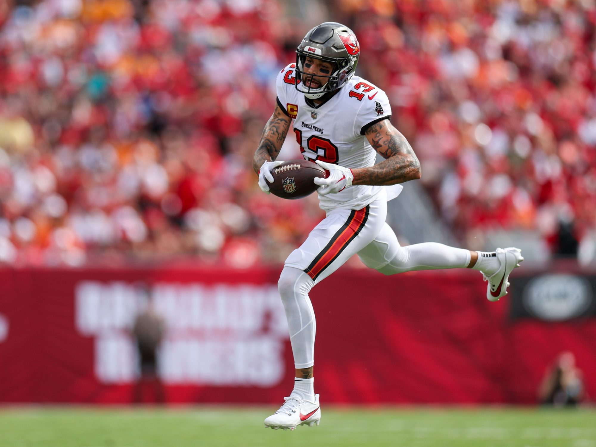 Sep 8, 2024; Tampa, Florida, USA; Tampa Bay Buccaneers wide receiver Mike Evans (13) catches a pass against the Washington Commanders in the first quarter at Raymond James Stadium.