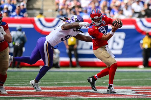 Sep 8, 2024; East Rutherford, New Jersey, USA; New York Giants quarterback Daniel Jones (8) is pressured by Minnesota Vikings linebacker Pat Jones II (91) during the second half at MetLife Stadium.