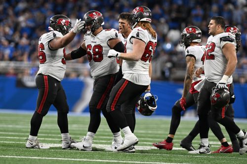 Sep 15, 2024; Detroit, Michigan, USA; Tampa Bay Buccaneers defensive tackle Greg Gaines (96) celebrates with guard Ben Bredeson (68) after the Buccaneers defense stopped the Detroit Lions on a fourth down play late in the fourth quarter at Ford Field.