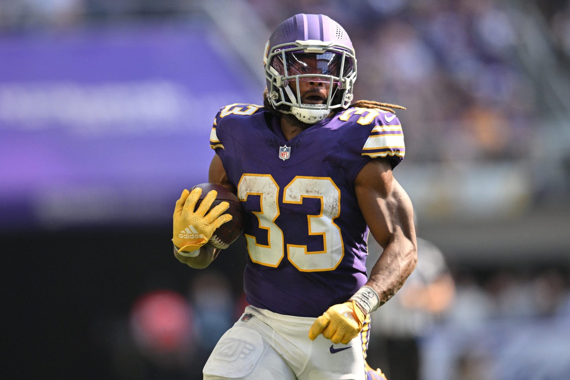 Sep 22, 2024; Minneapolis, Minnesota, USA; Minnesota Vikings running back Aaron Jones (33) runs the ball against the Houston Texans during the fourth quarter at U.S. Bank Stadium.