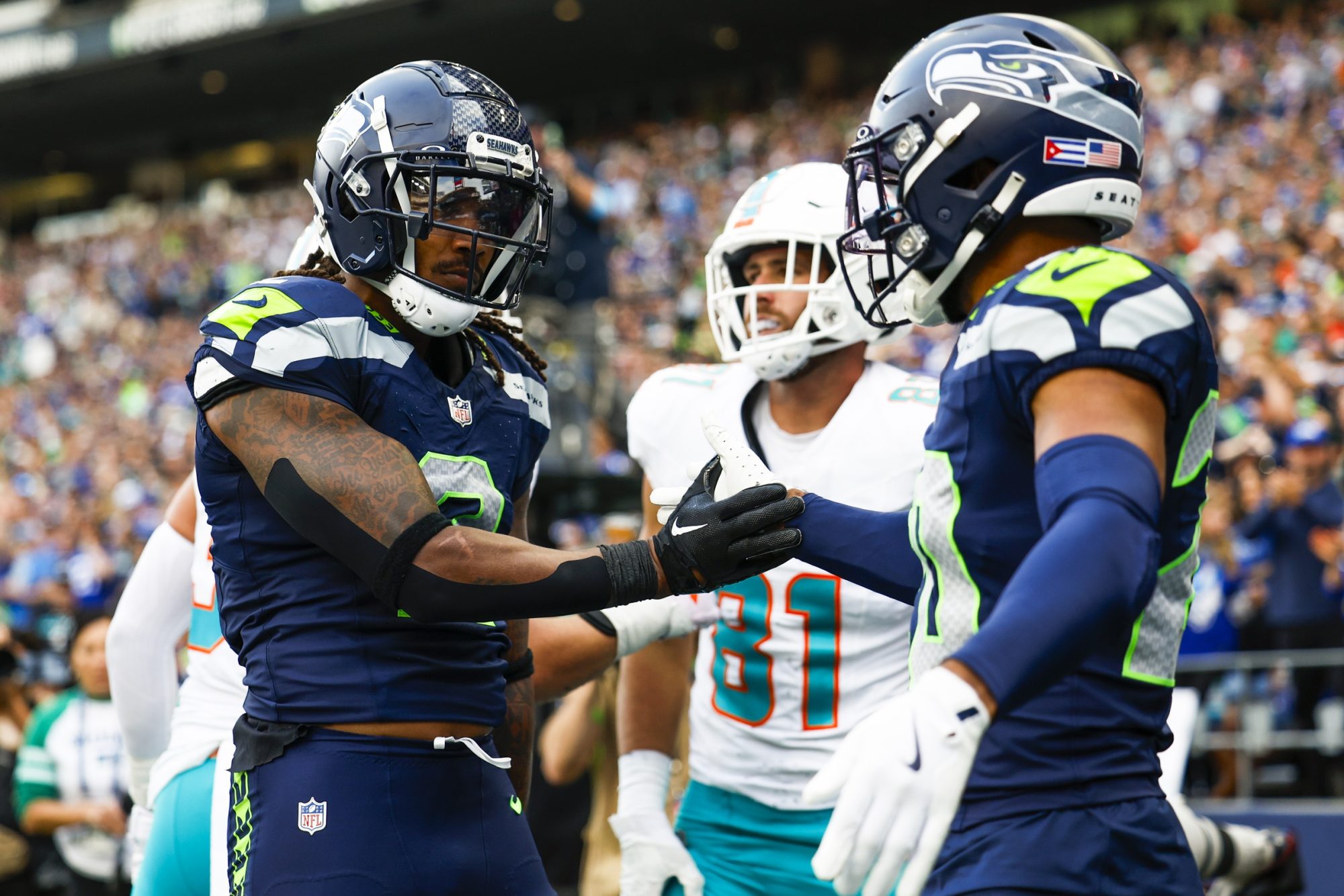 Sep 22, 2024; Seattle, Washington, USA; Seattle Seahawks safety Rayshawn Jenkins (2) celebrates with safety Julian Love (20) an incomplete pass to Miami Dolphins tight end Durham Smythe (81) during the fourth quarter at Lumen Field.